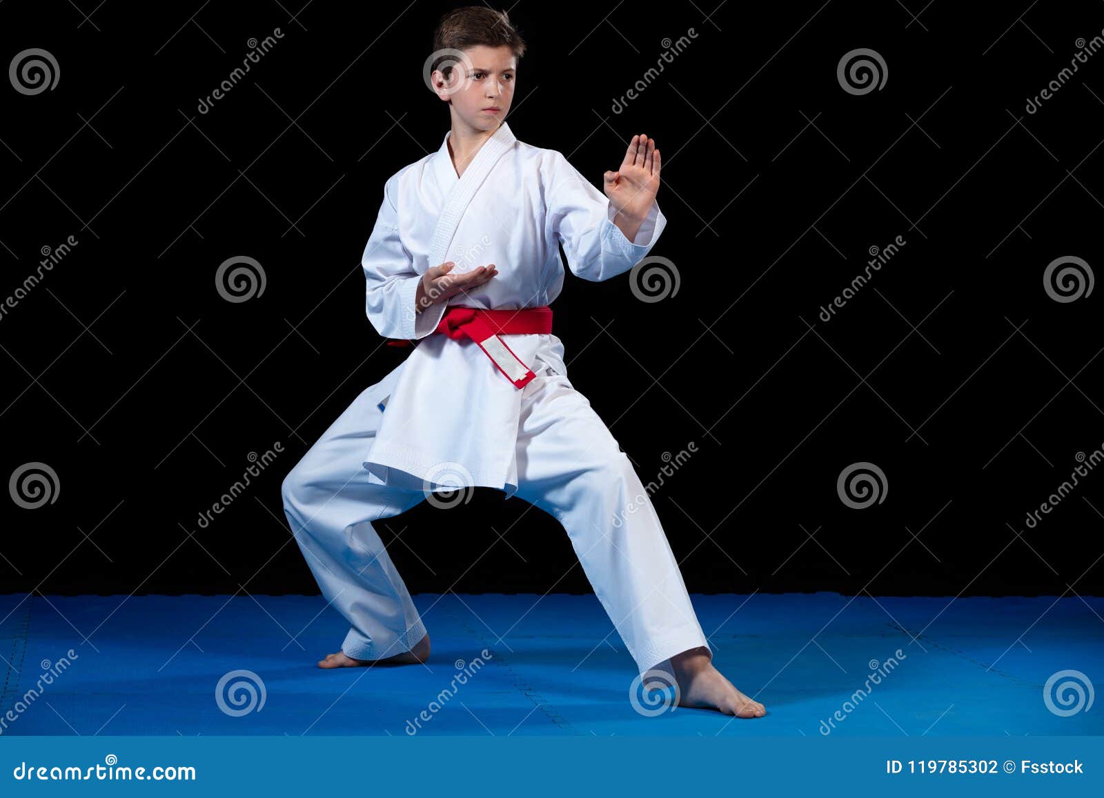 Young Boy Dressed in a White Karate Kimono with Red Belt. Stock Photo Image of little, kick