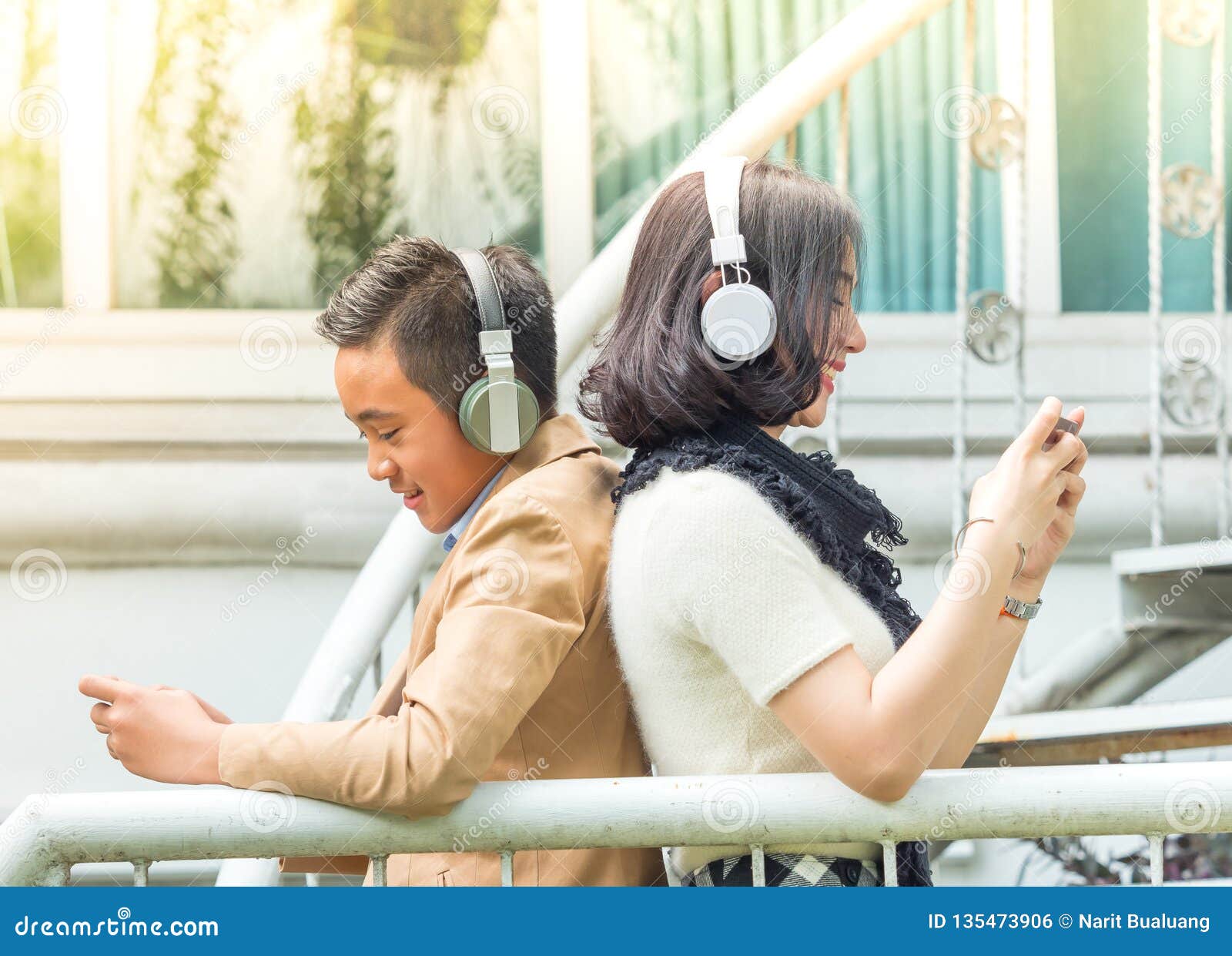 Young Boy and Girl Play Games and Listen To Music on Mobile Phones Stock  Photo - Image of hand, gamer: 135473906