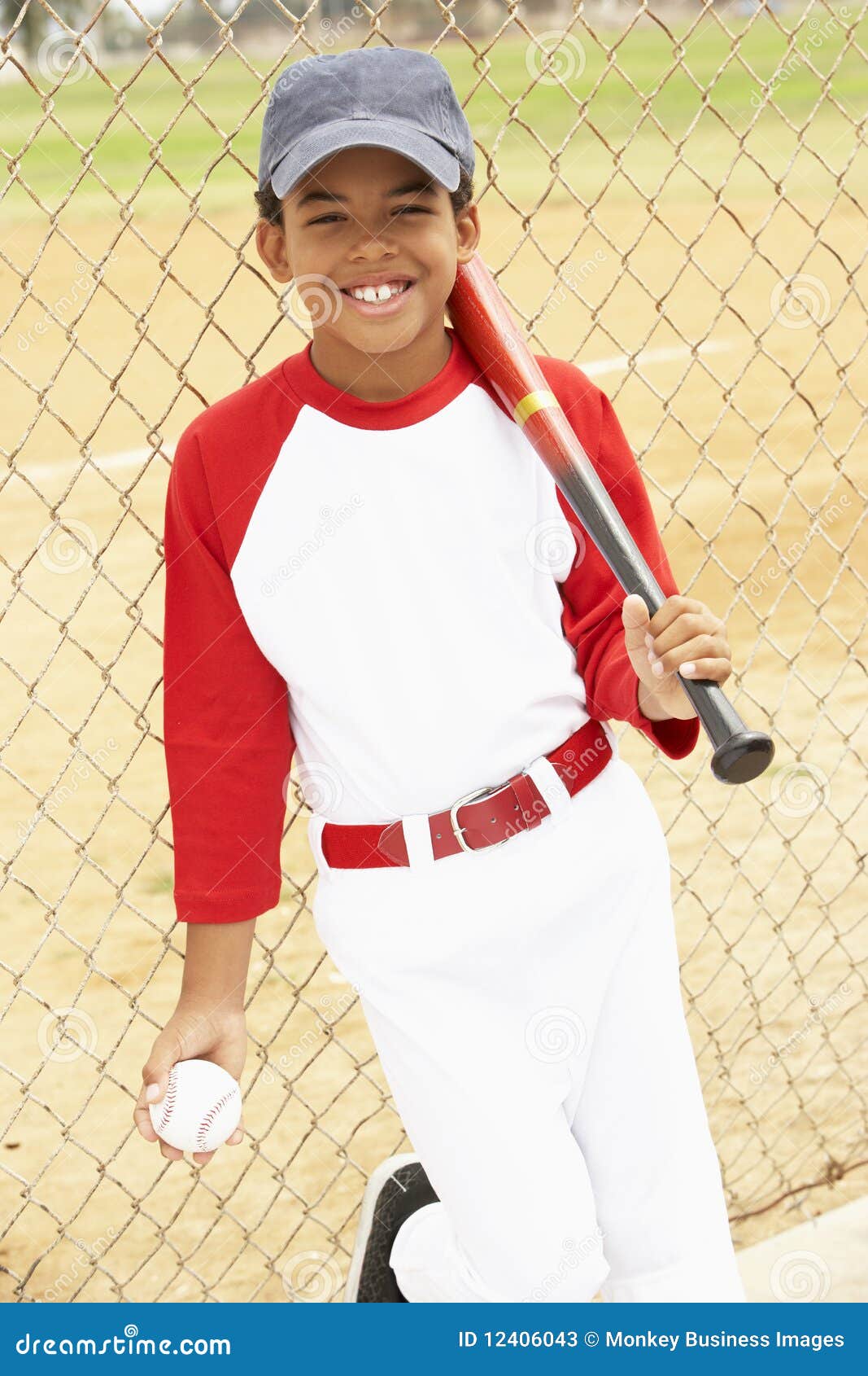 Young Boy Playing Baseball stock image. Image of uniform 12406043