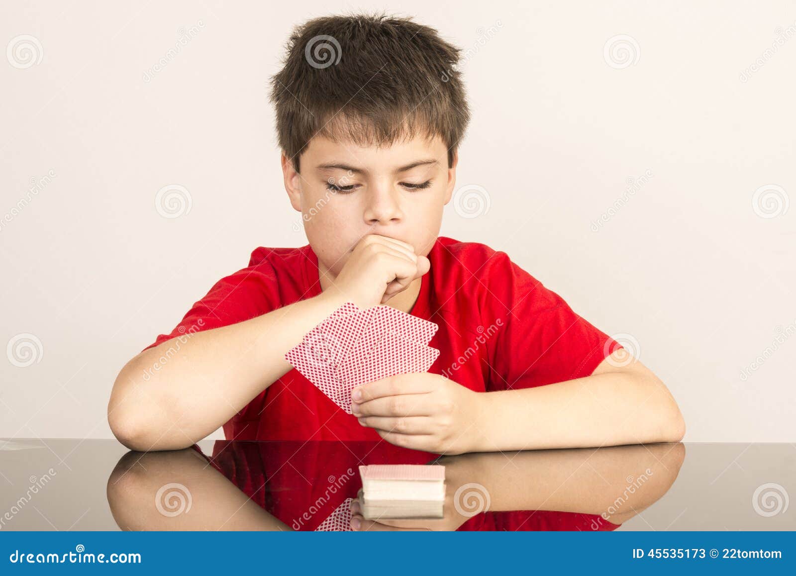 Young boy playing cards stock image. Image of indoors 45535173