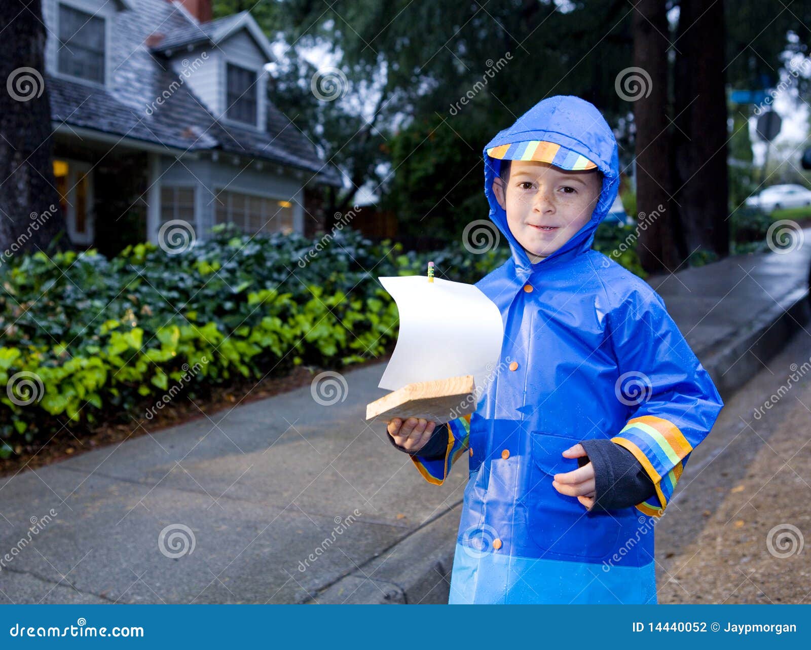 Young Boy Playing With Toy Boat In The Rain 2 Stock Ph