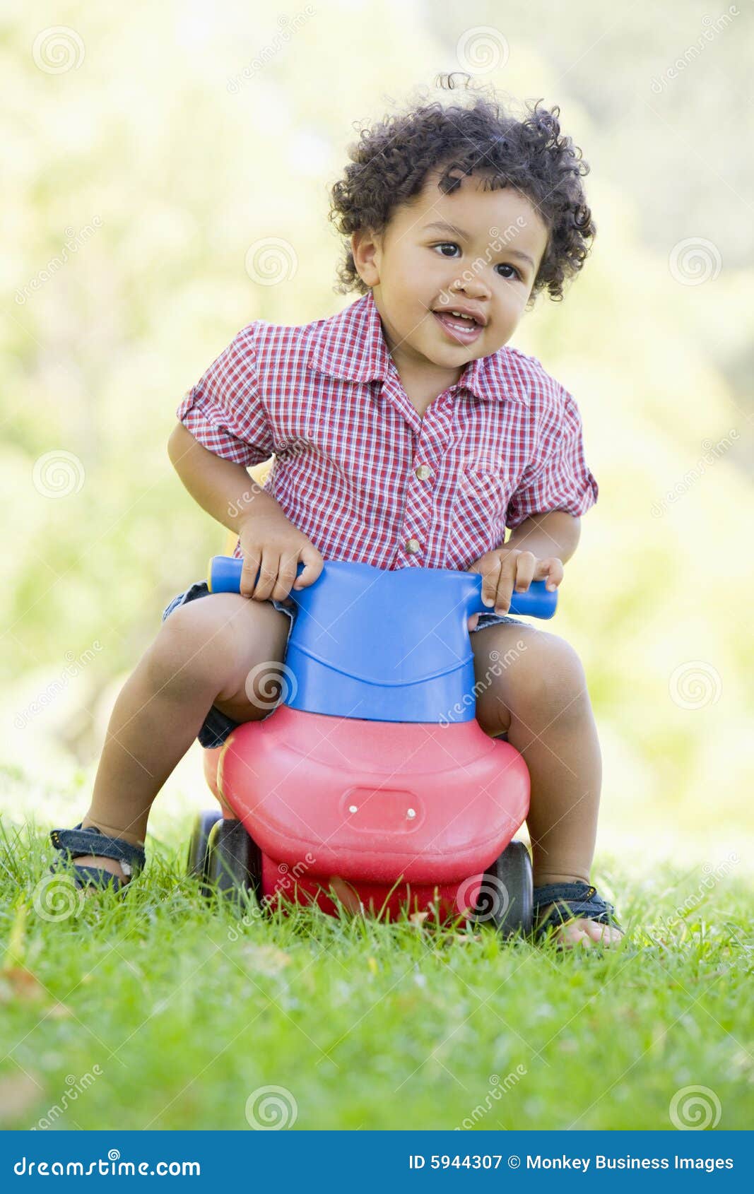 Young Boy Playing on Toy with Wheels Outdoors Stock Image - Image of ...