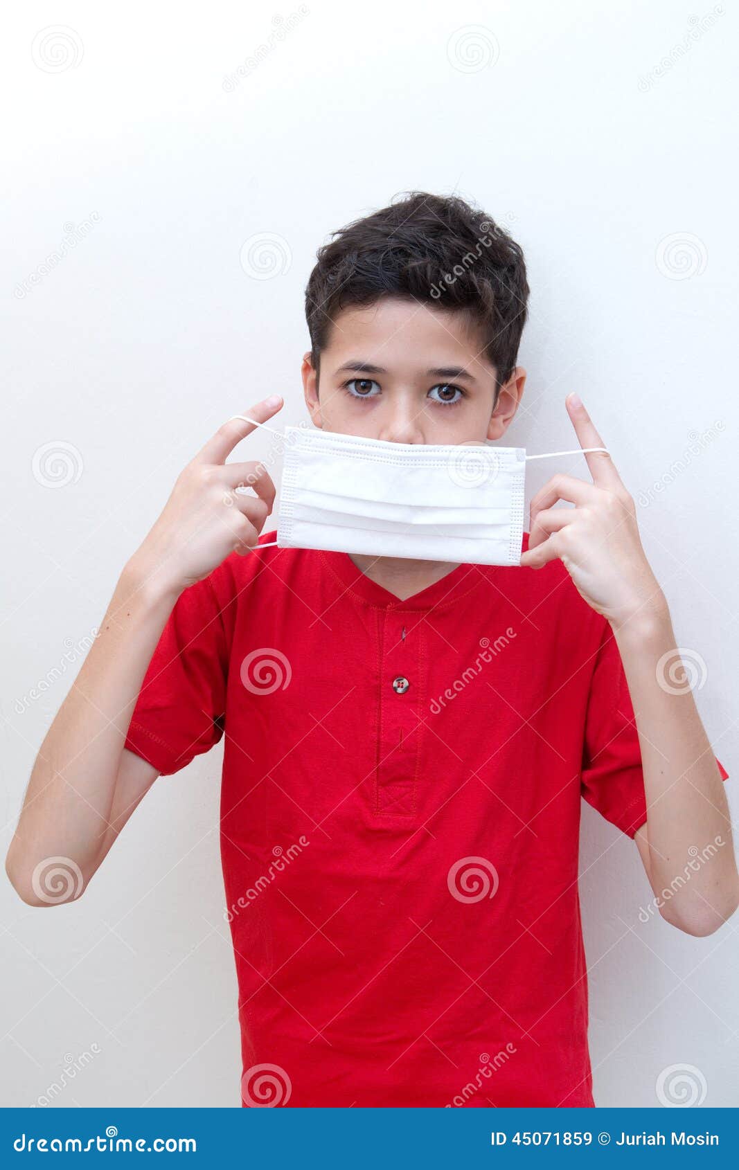 Young Boy Putting Face Mask on. Stock Image Image of child