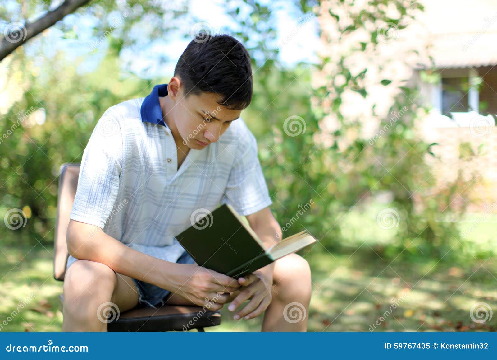 The Young Boy Reading Book outdoors