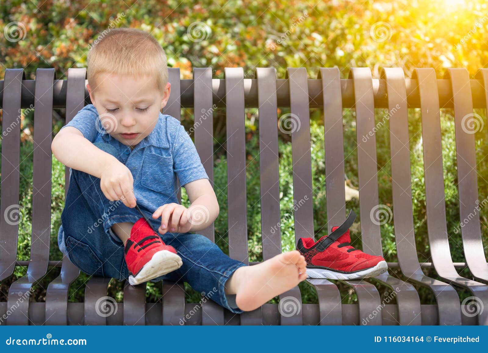 little boy putting on shoes Stock Photo - Alamy