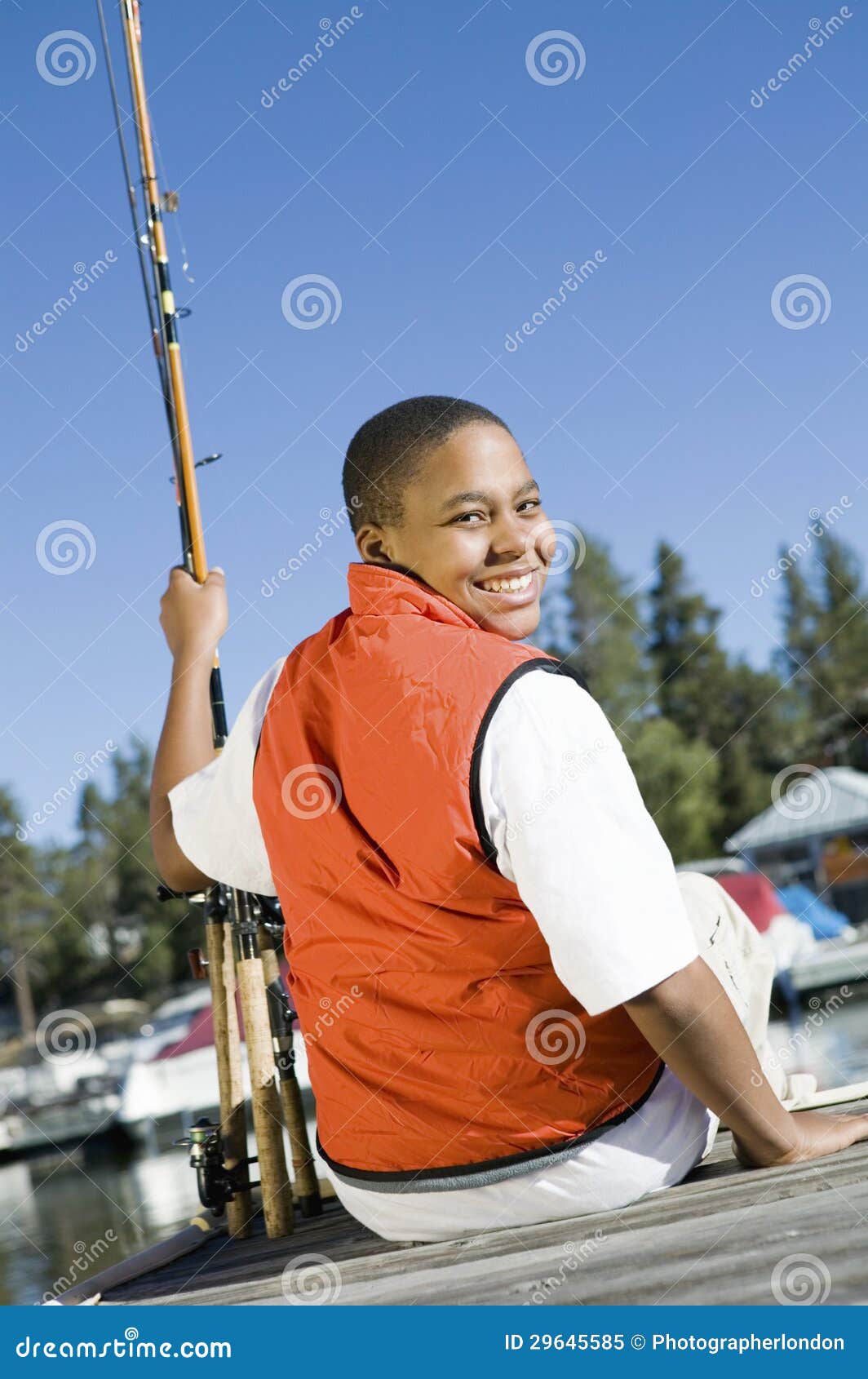 Young Boy Sitting on Pier with Fishing Rods Stock Image - Image of people,  lifestyle: 29645585