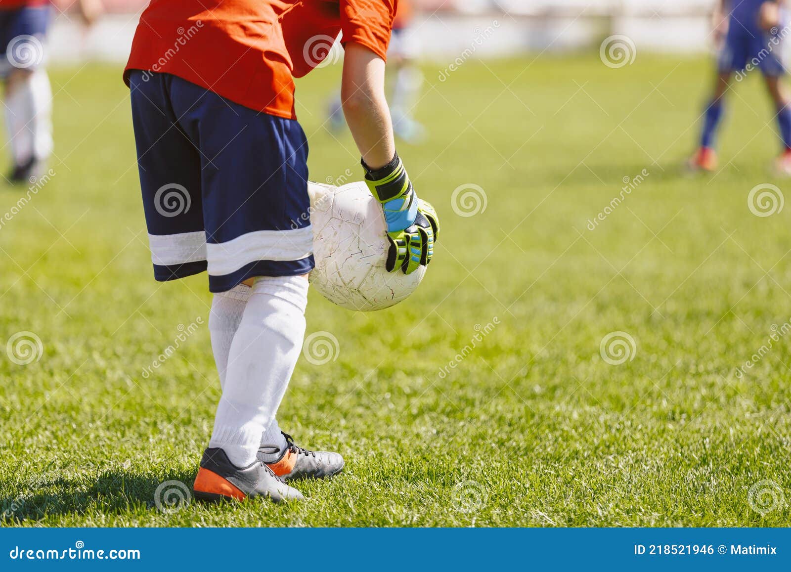 Young Boy Soccer Football Goalkeeper Holding Ball in Hand Gloves. School Kids Playing Sports Game
