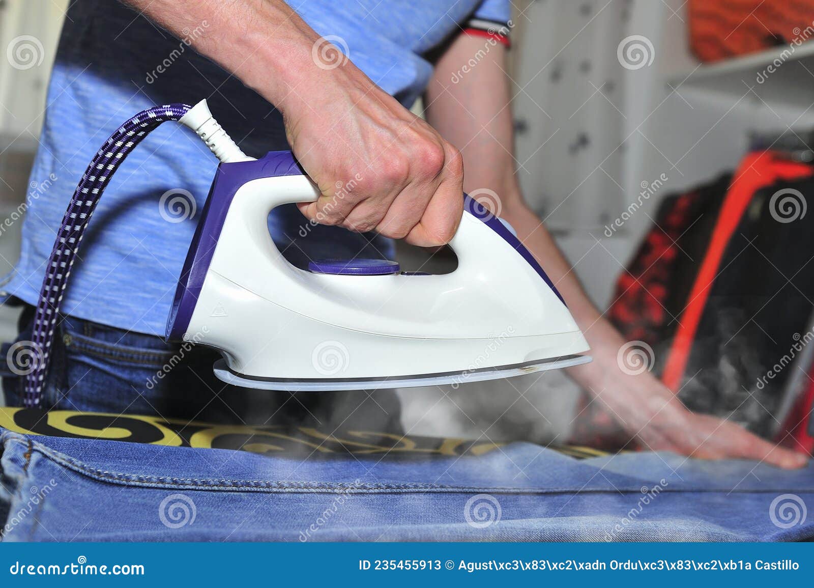 Young Boy Steam Ironing Some Jeans. Stock Image Image of chores