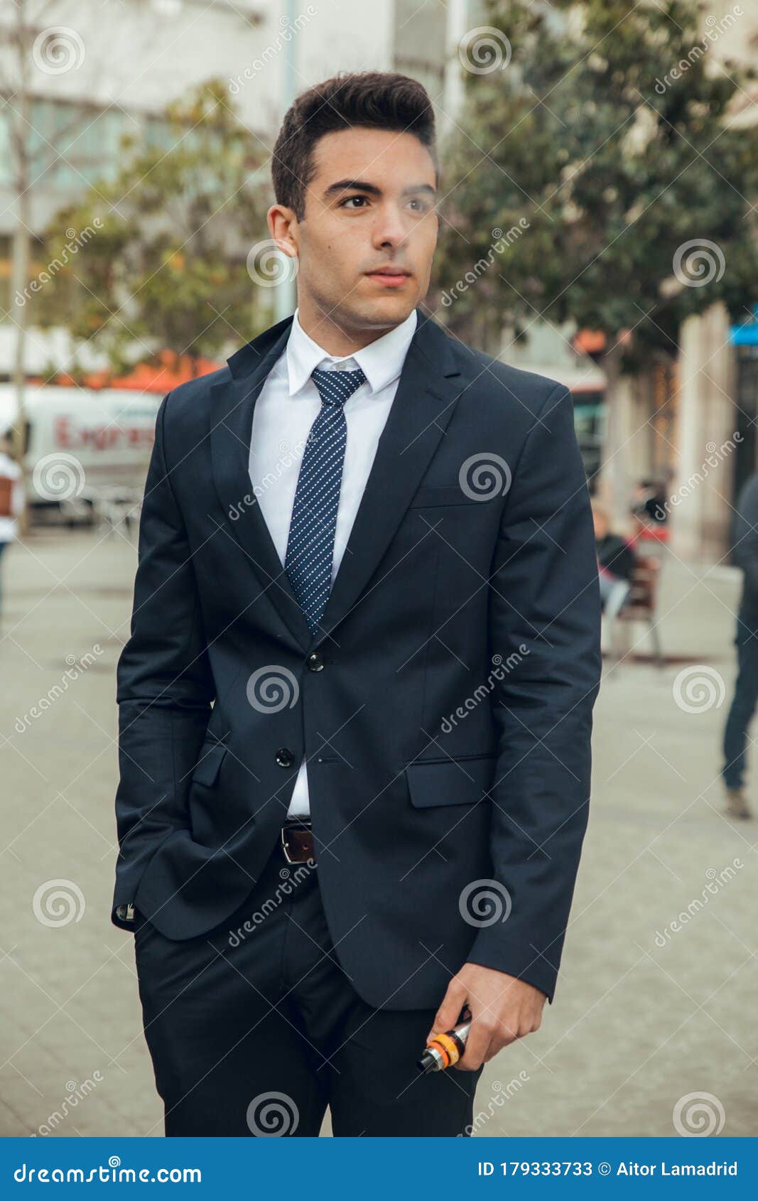 boy in suit smoking with vaper