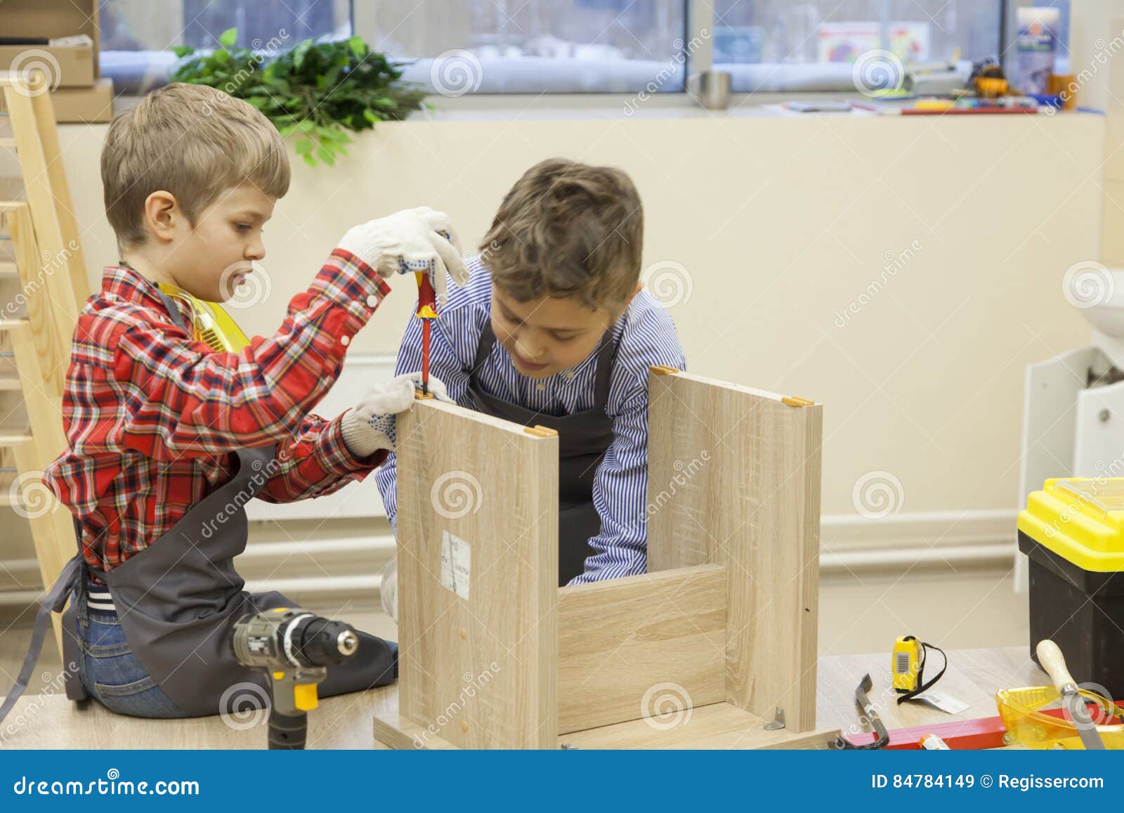 young boys construct wooden stool