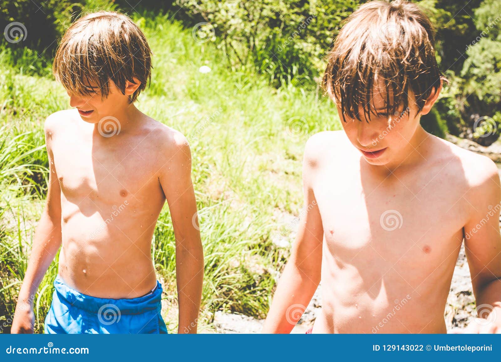 Young Boys Have Fun At The Small River Stock Photo I