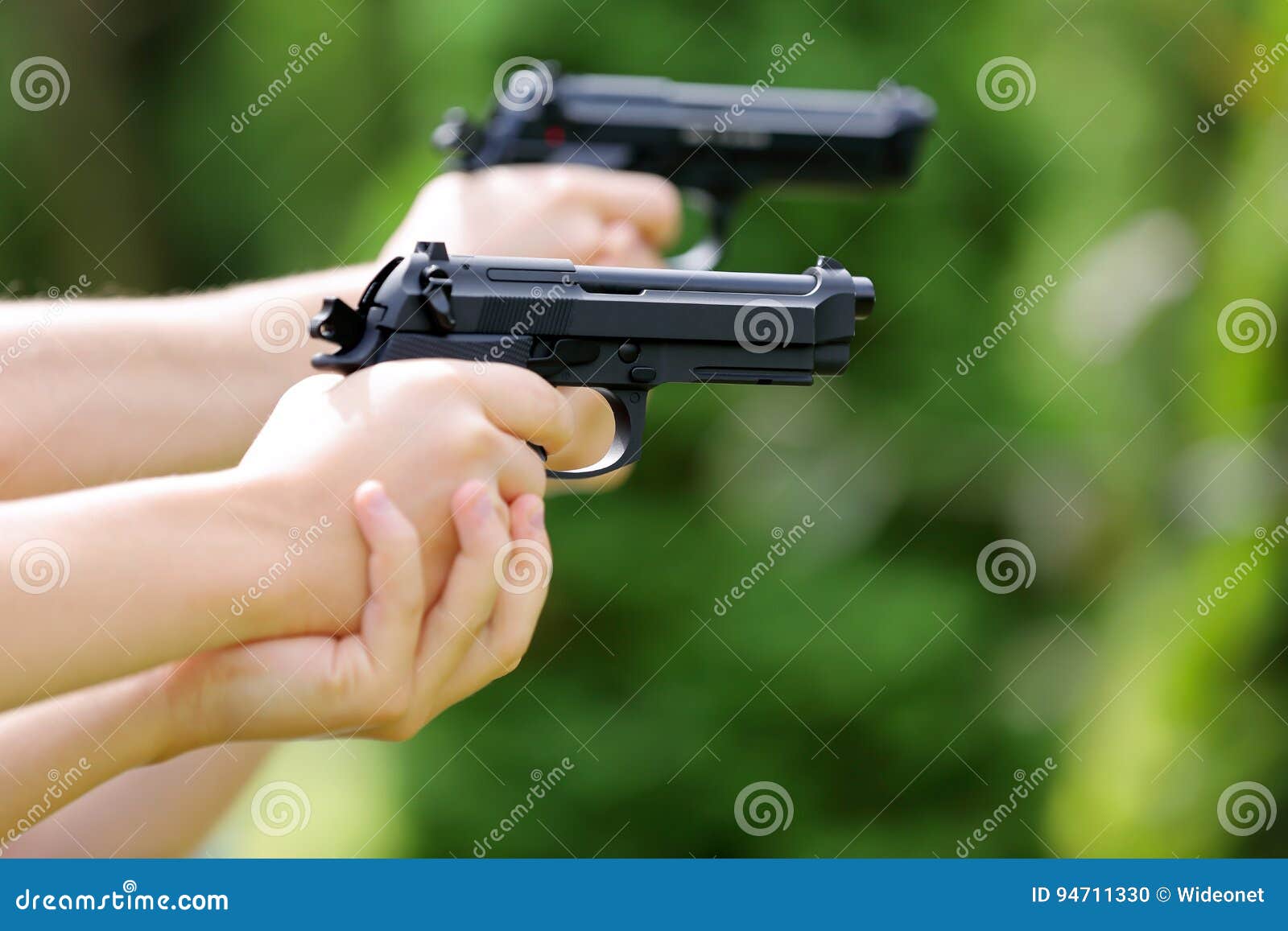 Young Boys Practice Shooting Guns on Outdoor Stock Photo - Image