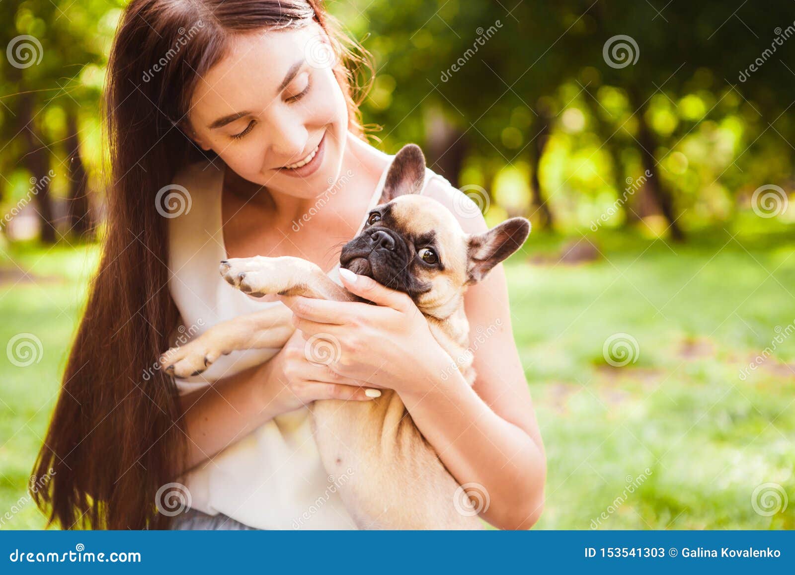 Young Brunette Girl With A Little Puppy French Bulldog