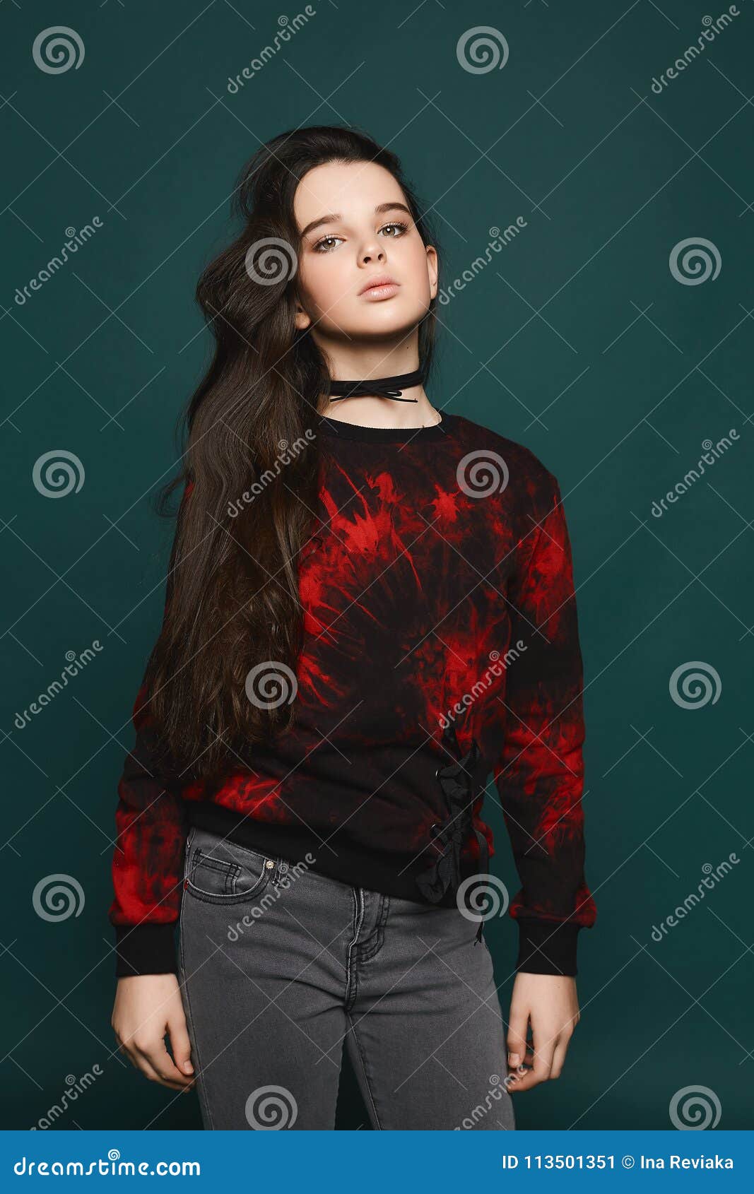 Young Brunette Teen Model Girl Posing at Dark-green Background Stock Image 