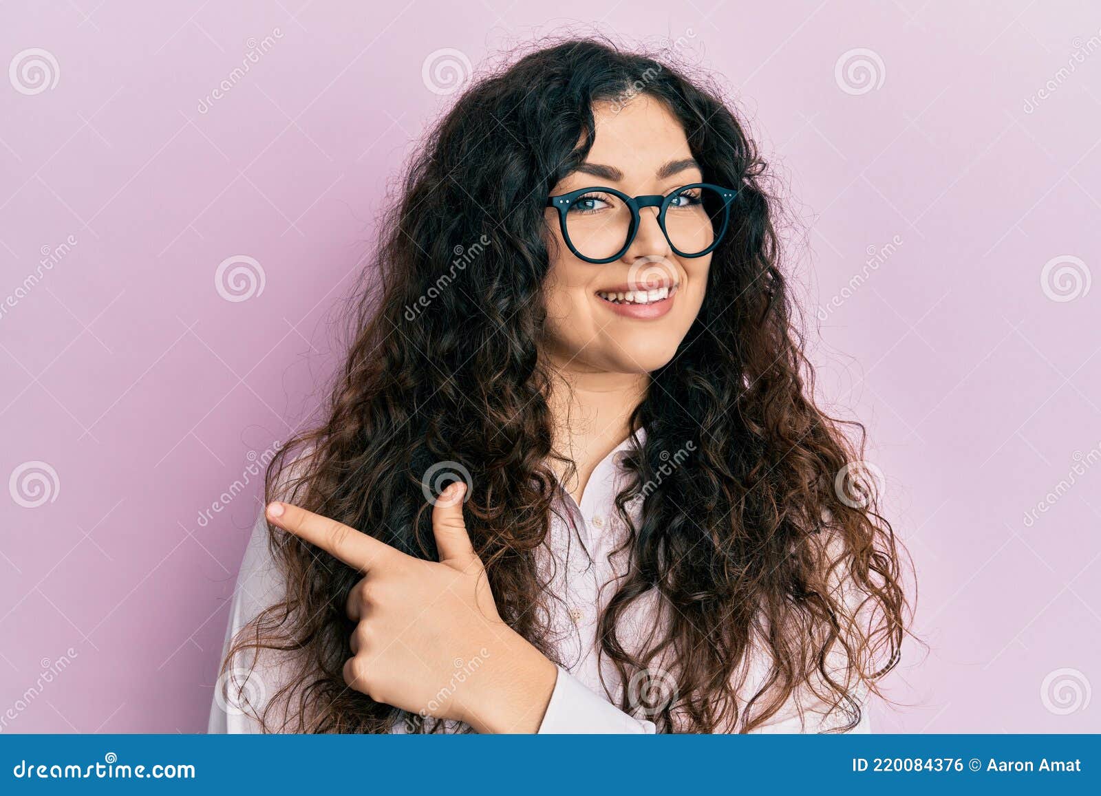 Young Brunette Woman With Curly Hair Wearing Casual Clothes And Glasses Cheerful With A Smile Of