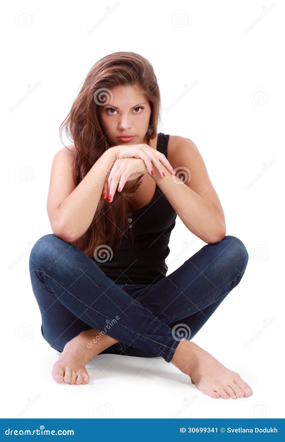 Young Brunette Woman Sits On Floor With Bended Knees Stock Image