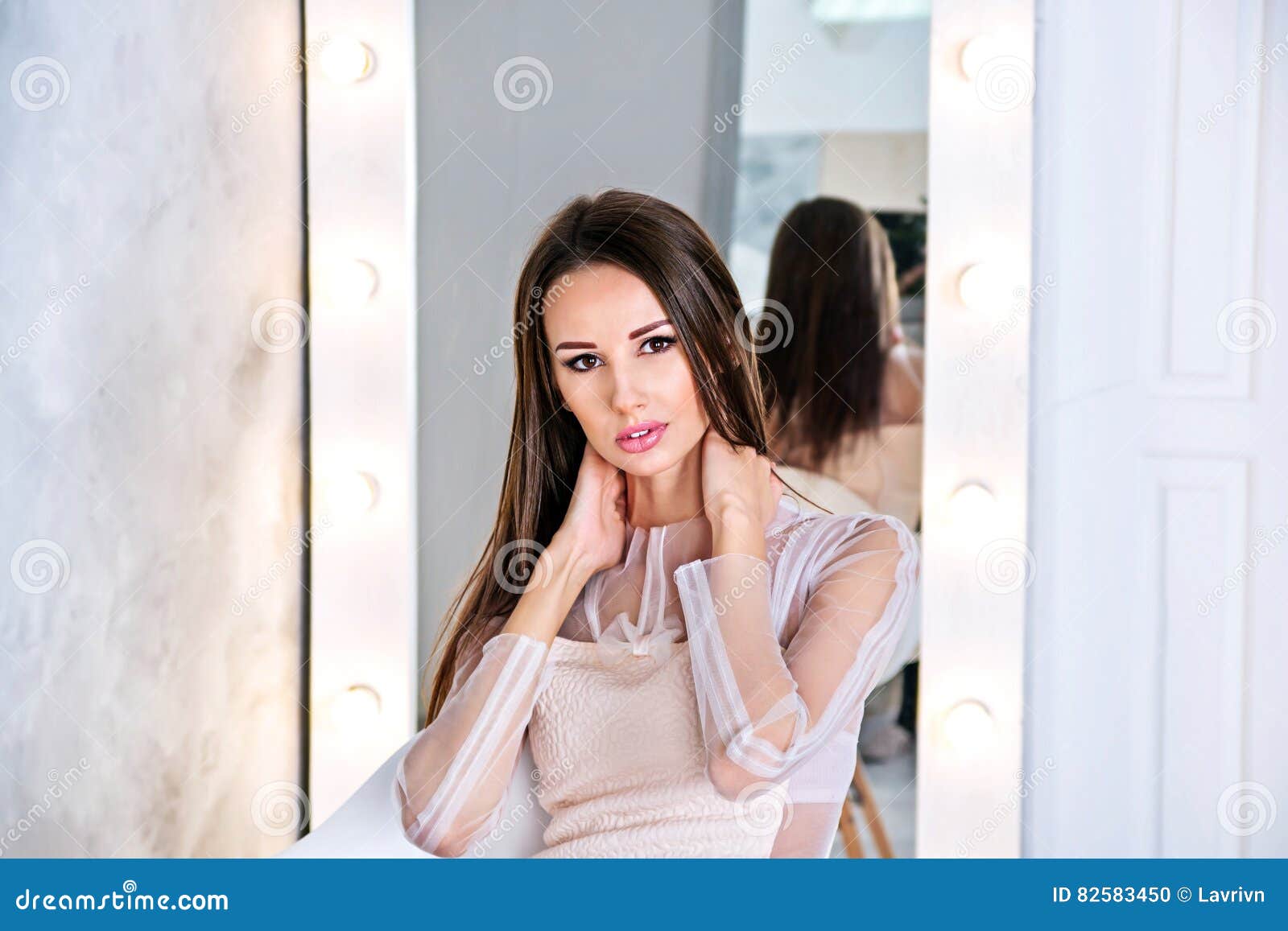 Young Brunette Woman with Straight and Silky Hair Sitting in Front of Mirror on Grey Background with Hands on Neck Stock Photo - Image of front, chair: 82583450 Young Brunette Woman with Straight and Silky Hair Sitting in Front of Mirror on Grey Background with Hands on Neck Stock Photo - Image of front, chair: 82583450