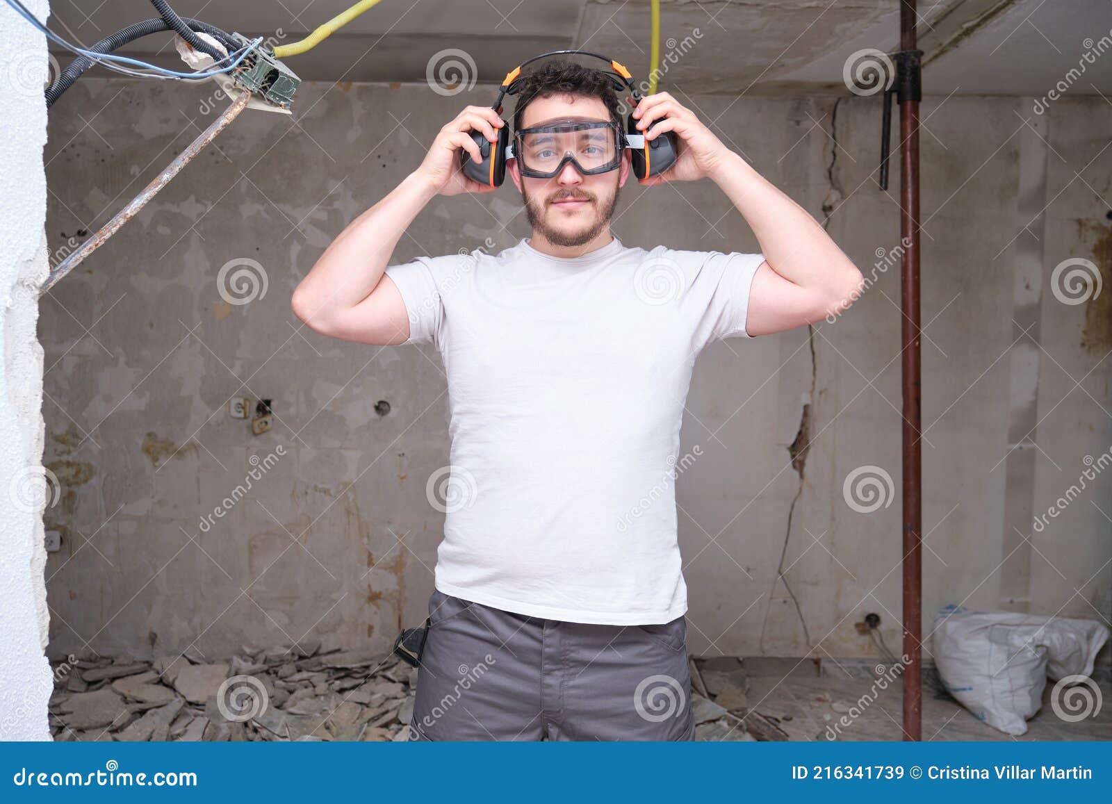 Young Builder Wearing Hearing Protection and Safety Glasses at a