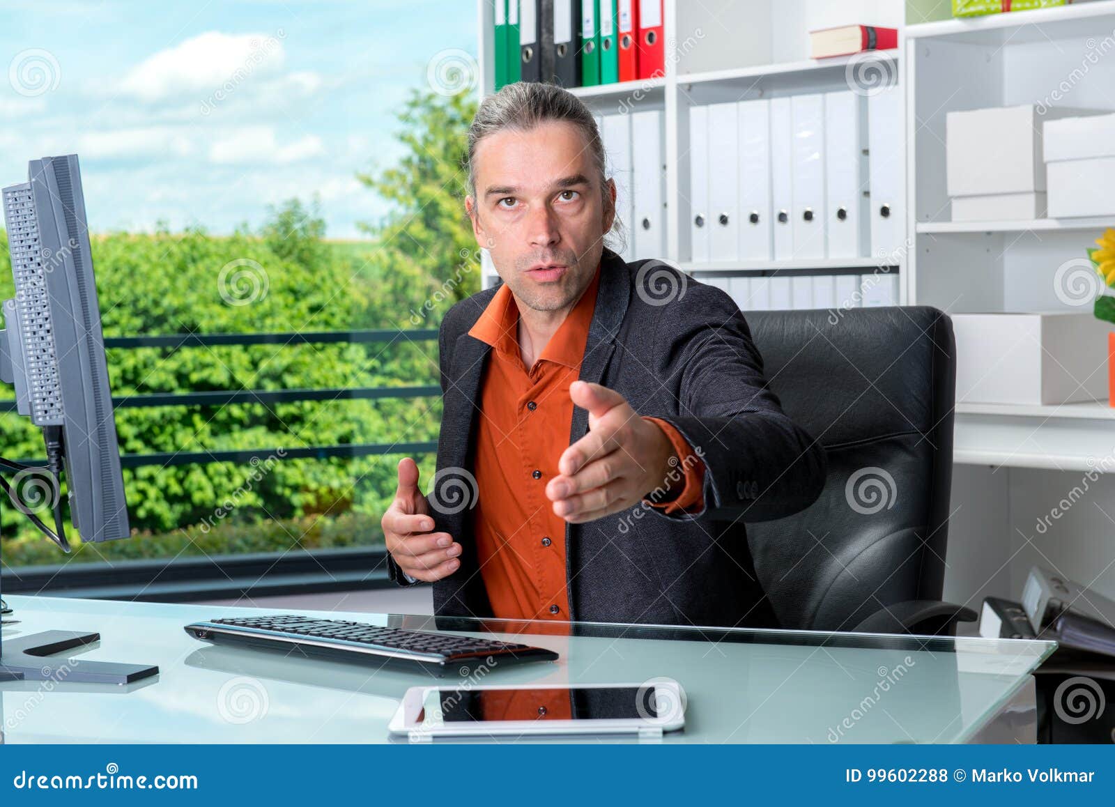 business man behind his desk greeted a client