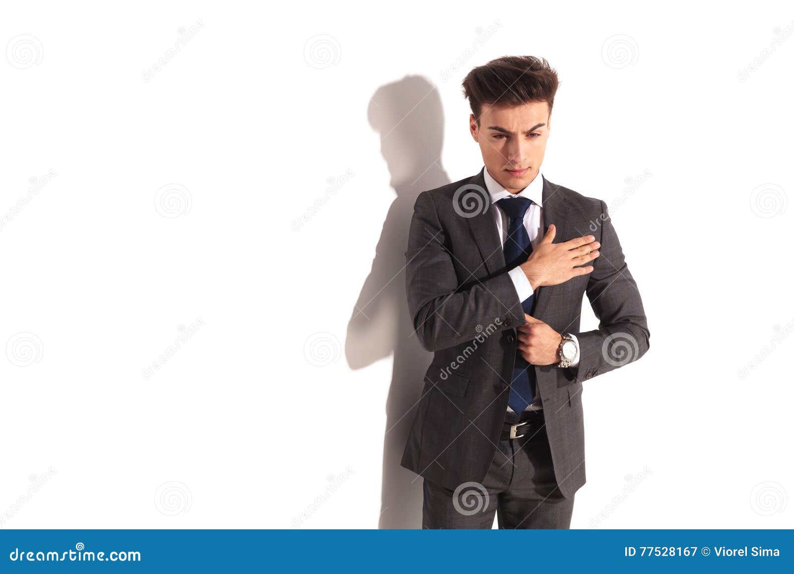 Young Business Man in Solemn Pose with Hand on Chest Stock Image