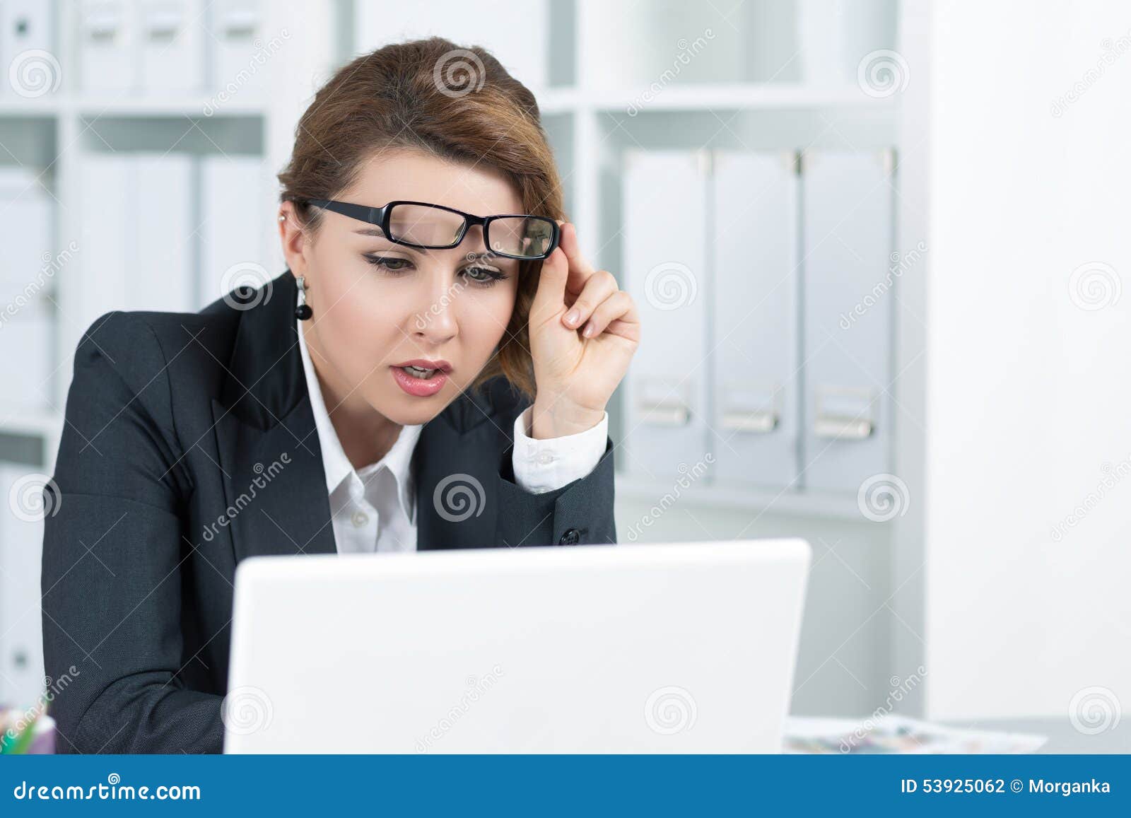 young business woman looking intently at laptop