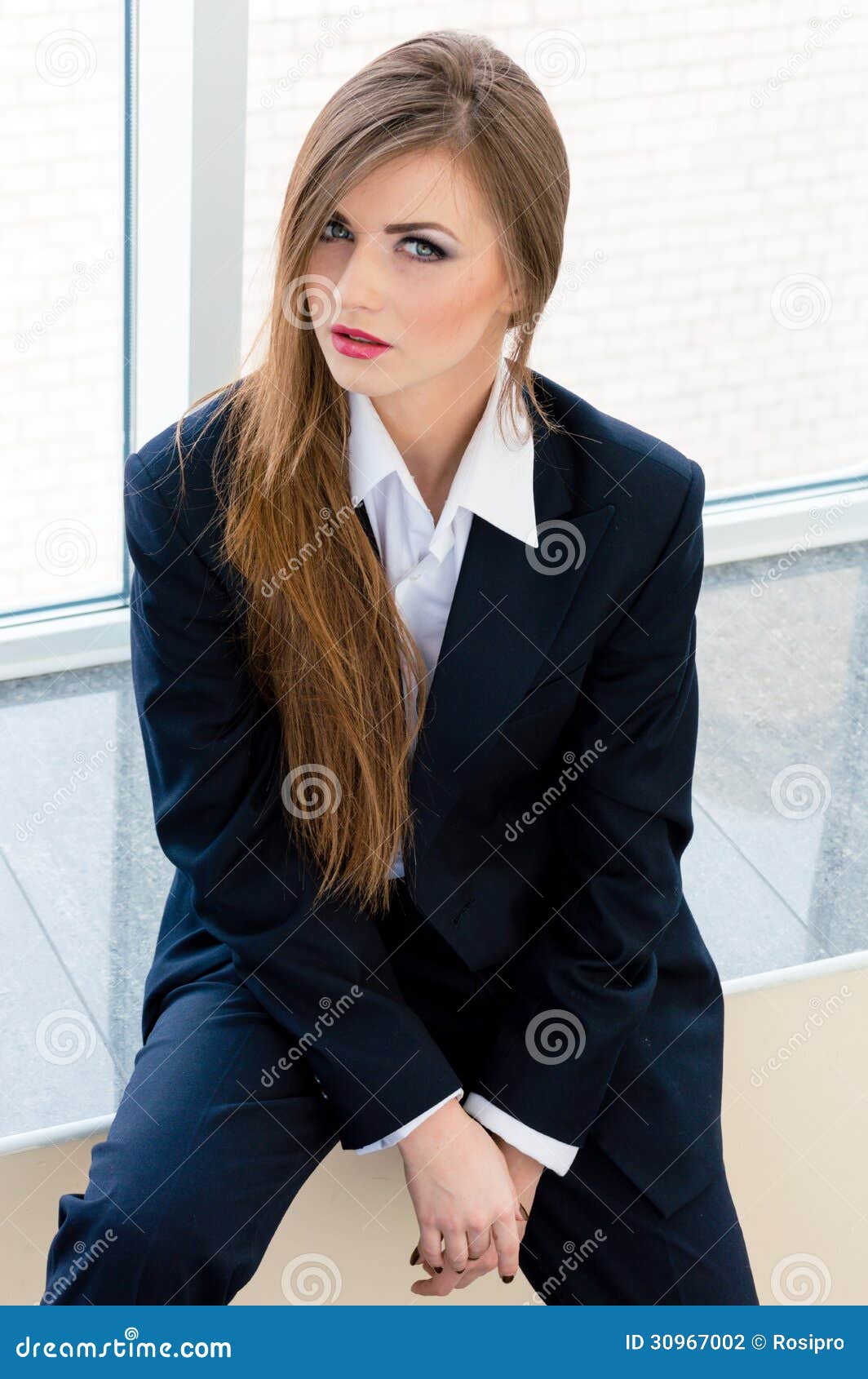 young-business-woman-wearing-man-s-suit-office-businesswoman-looking-bossy-30967002.jpg