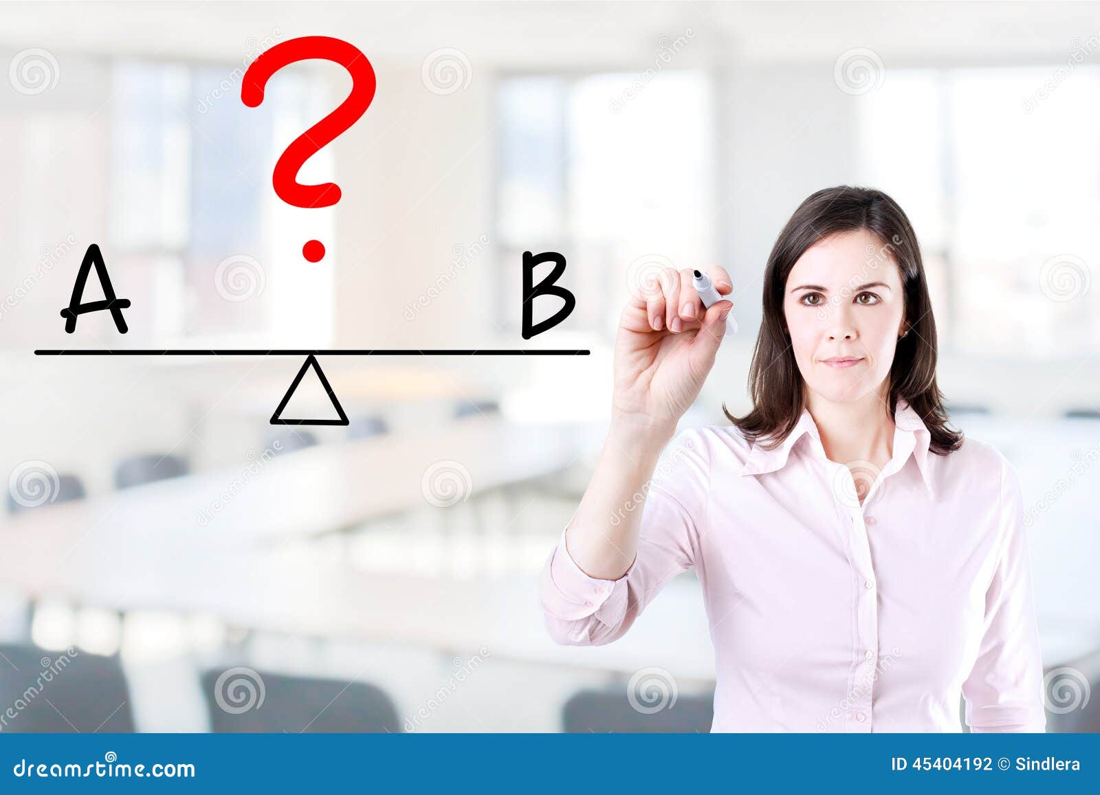 young business woman writing a and b compare on balance bar. office background.