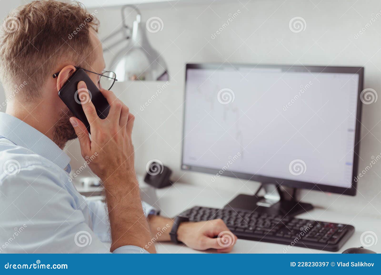 young businessman brocker on mobile phone in office. investment, trading stock on bear market