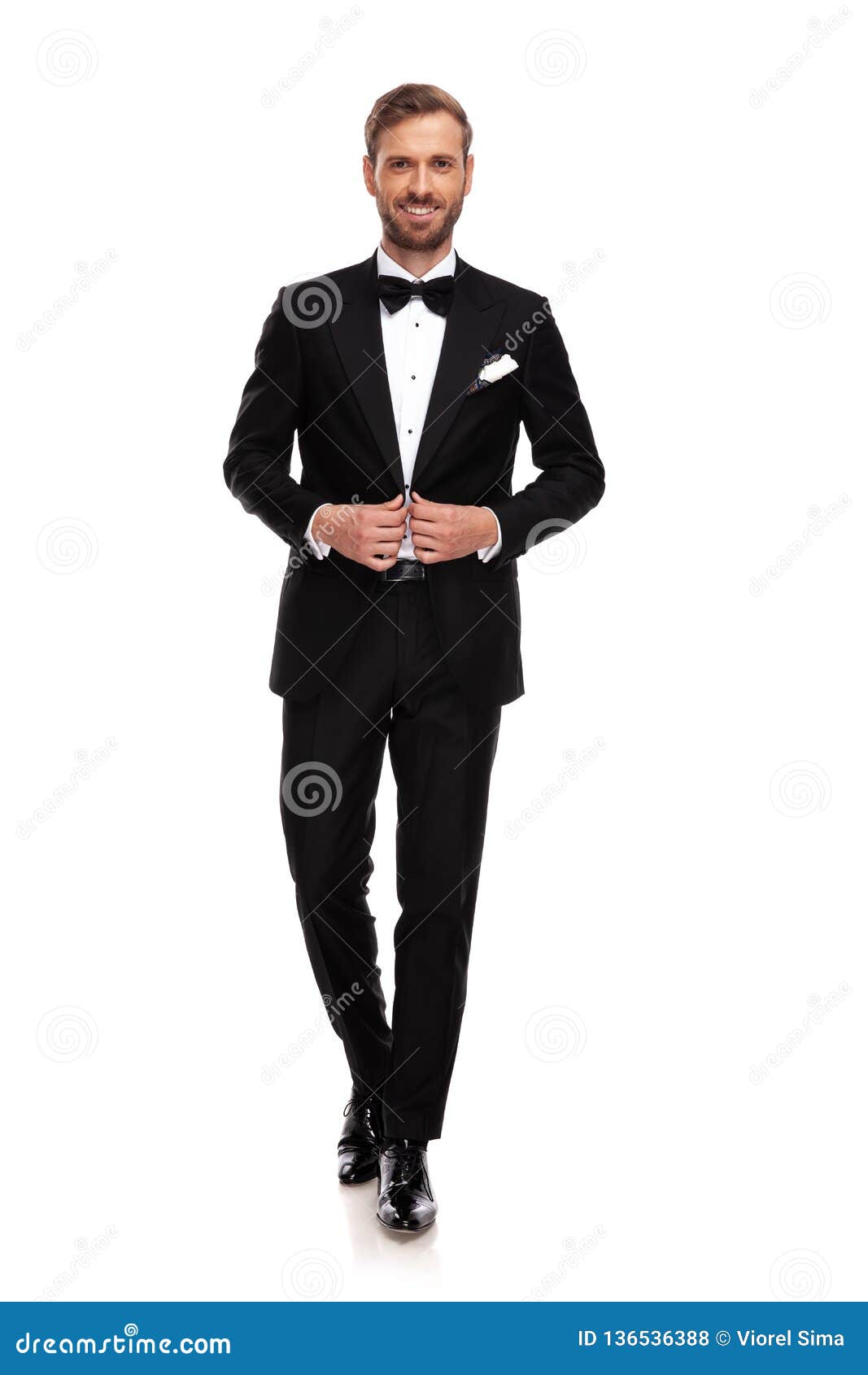 Young Businessman Buttoning His Black Suit While Stepping Forward Stock ...