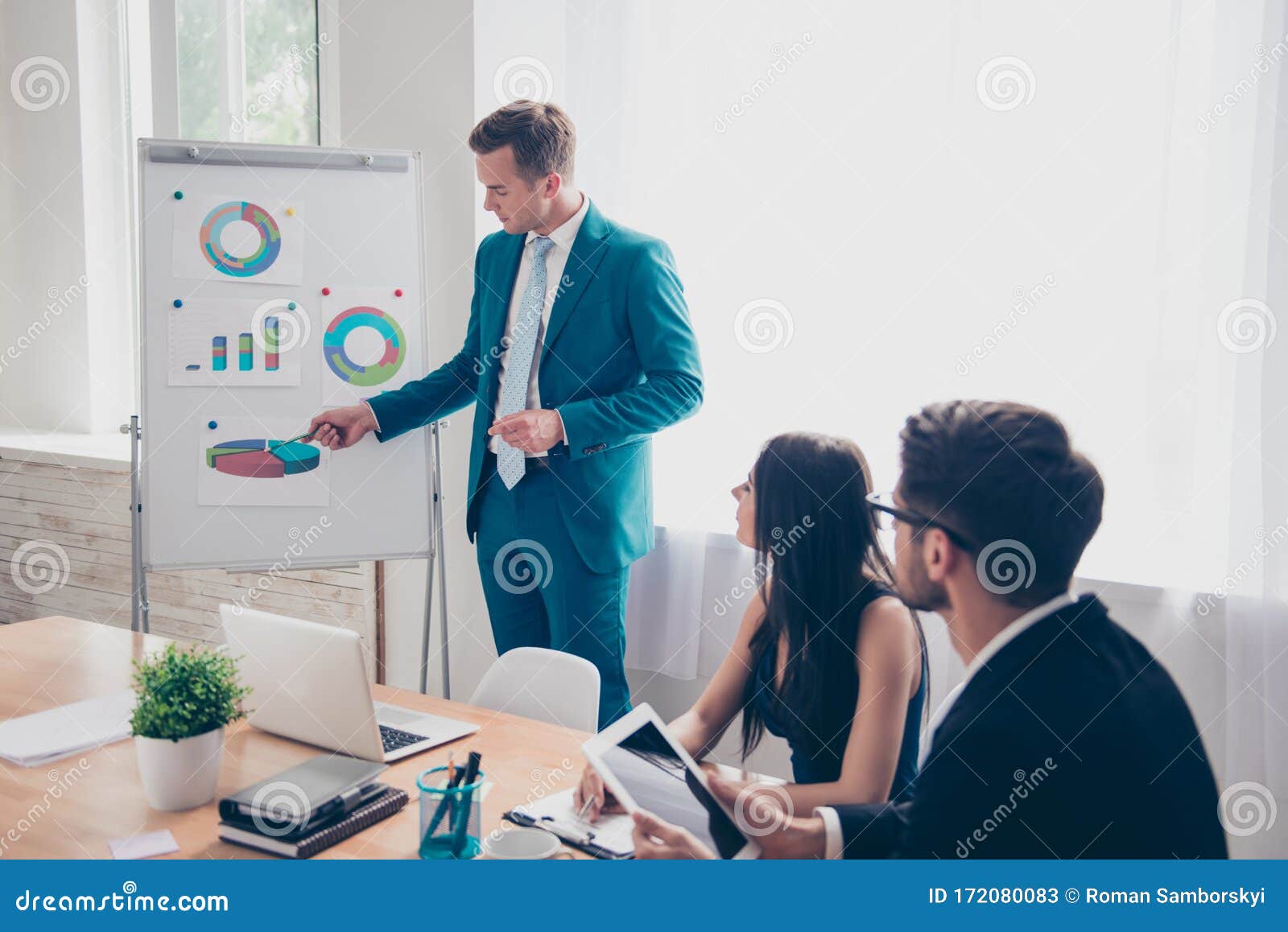 young businessman making presentation and showing diagrama on whiteboard