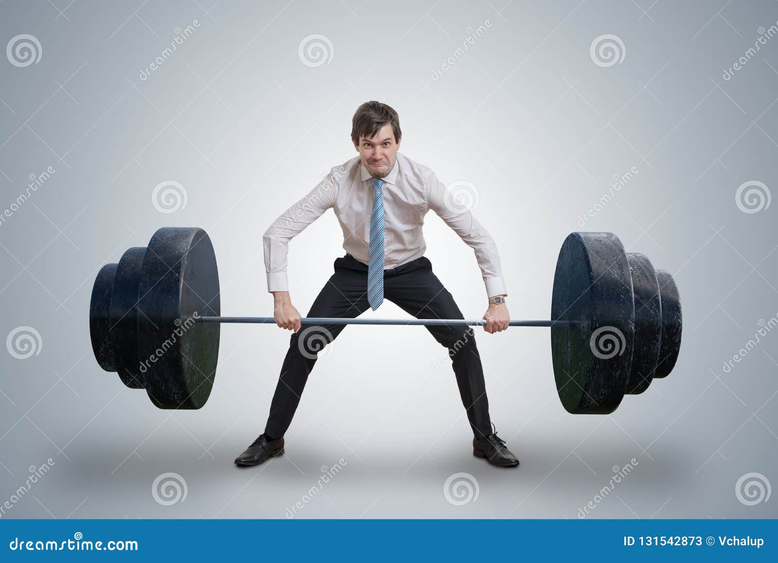 young businessman in shirt is lifting heavy weights.
