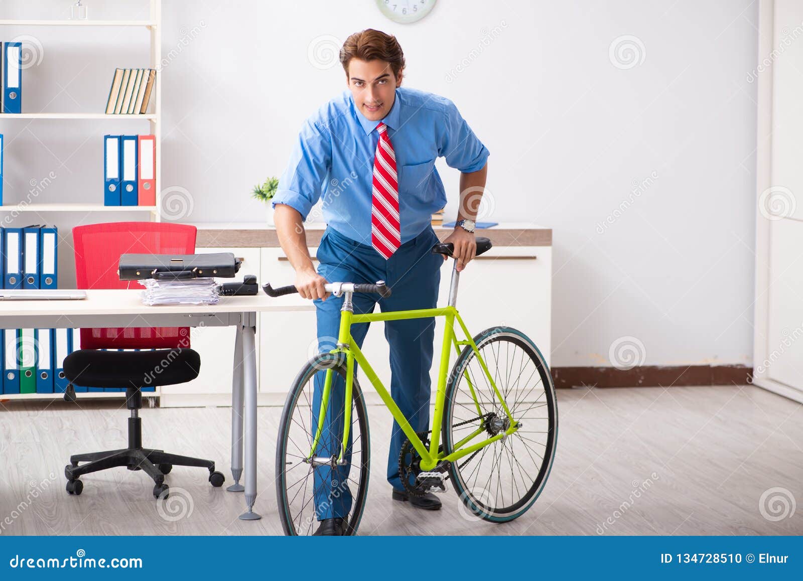 The Young Businessman Using Bike To Commute To the Office Stock Photo