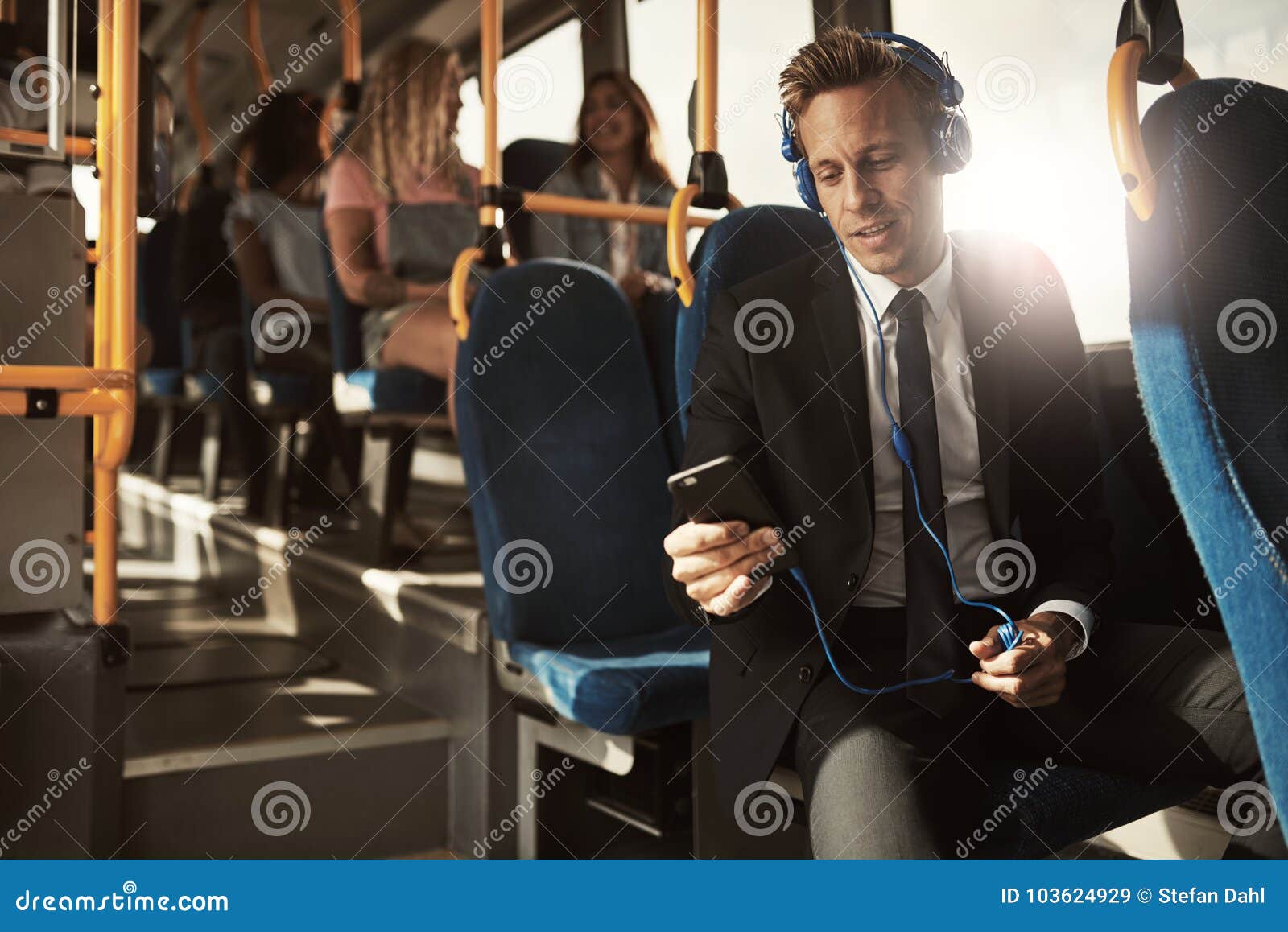 young businessman listening to music on his morning commute