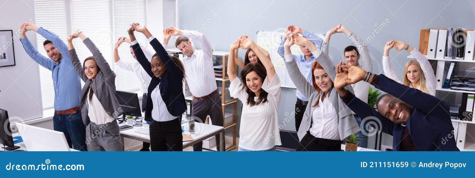 young office workers doing stretching exercise at workplace