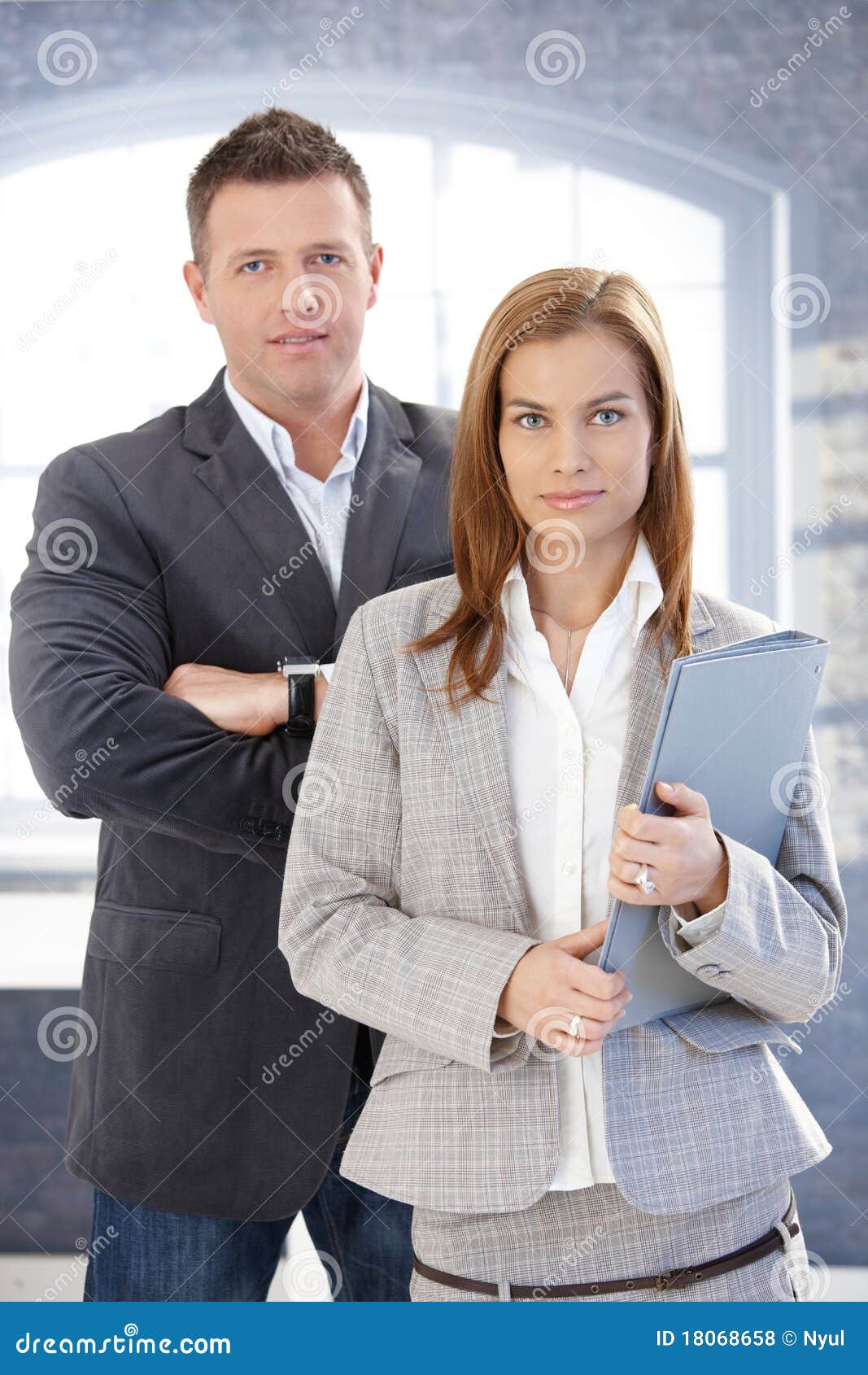 young businesspeople standing in office