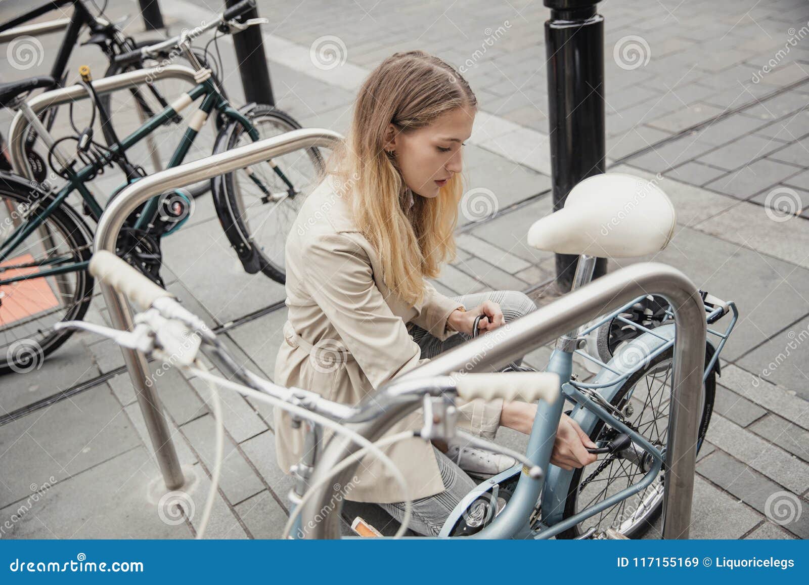 locking up her bicycle