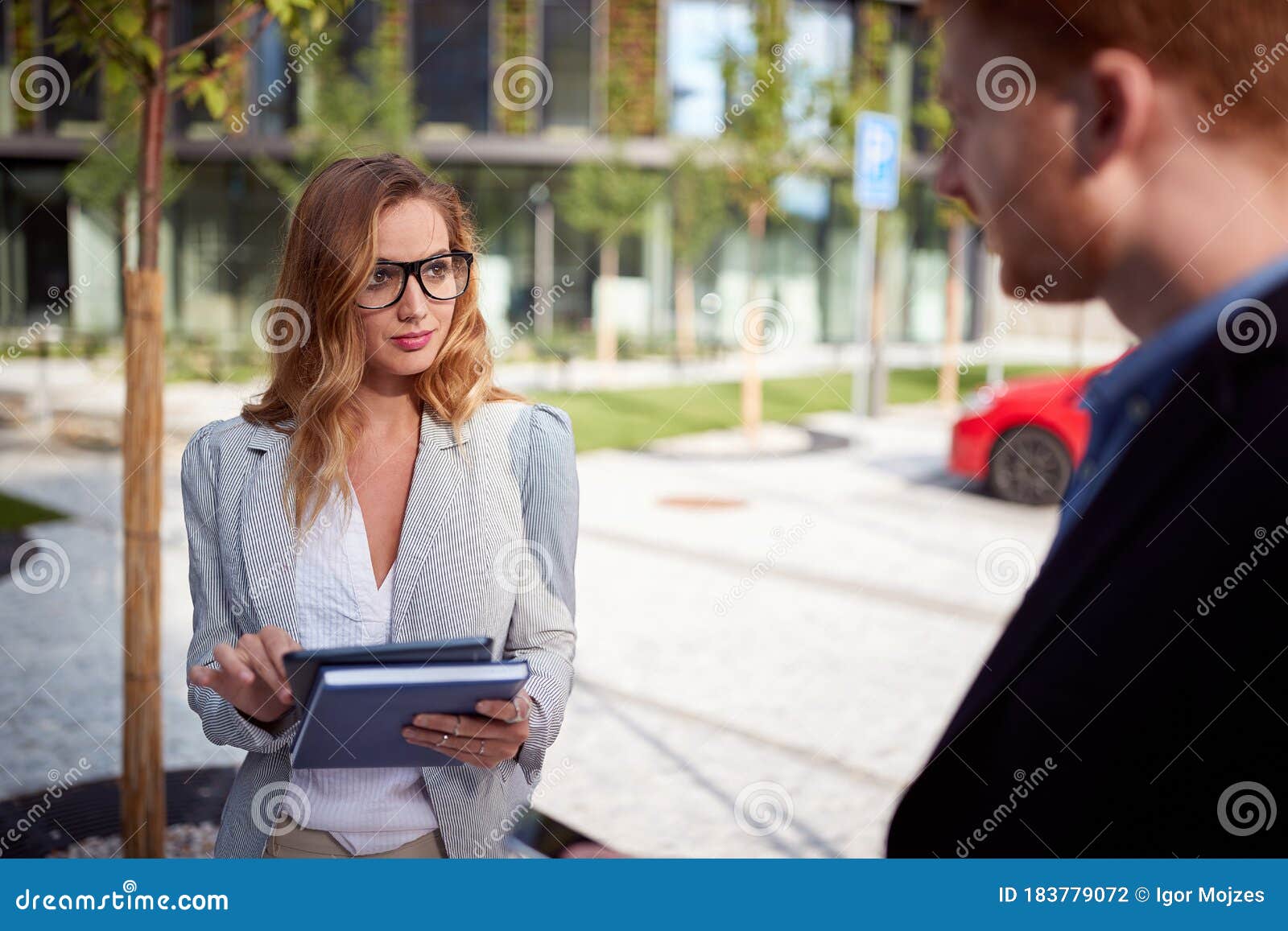 young businesswoman looking seductively  her interlocutor outdoor in front of business building. outdoor, unofficial, meeting,