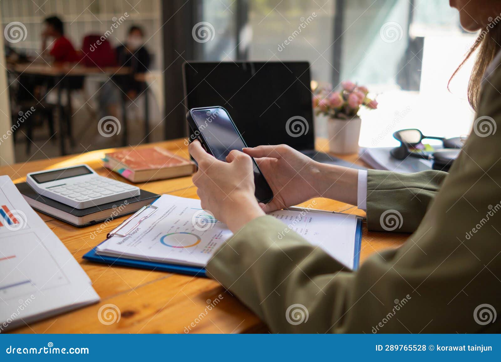 a young businesswoman is reviewing documents and their information to compile statistics and summarize annual results. the concept