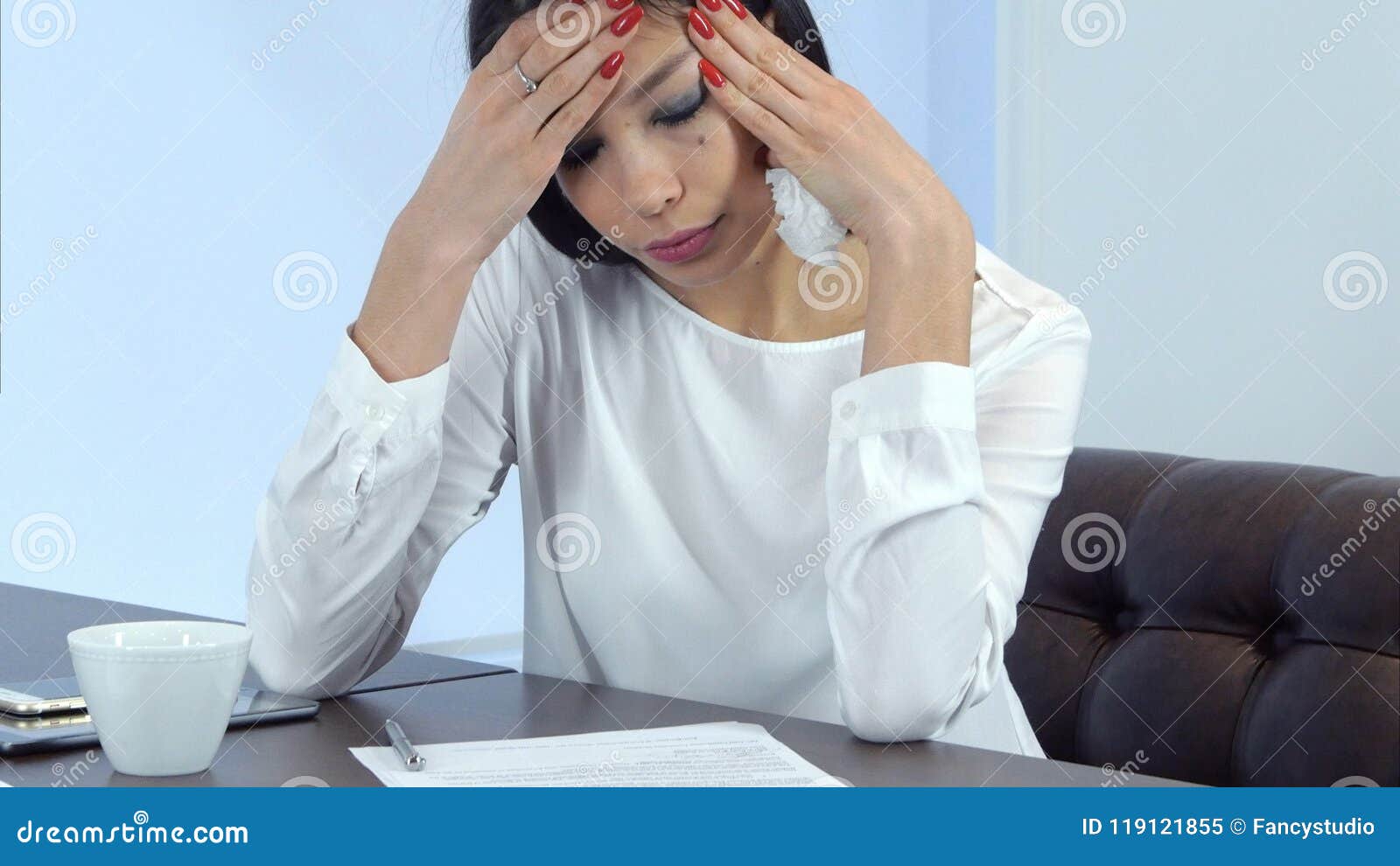 young busy woman feeling not well but continuing signing papers