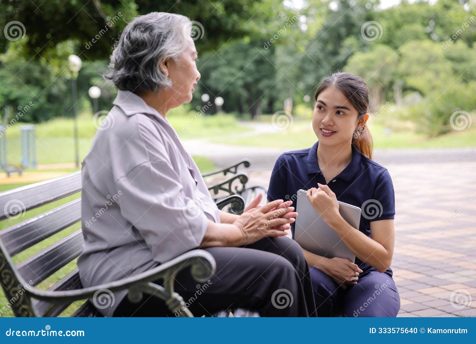 young caregiver discussing senior care plans with an elderly woman