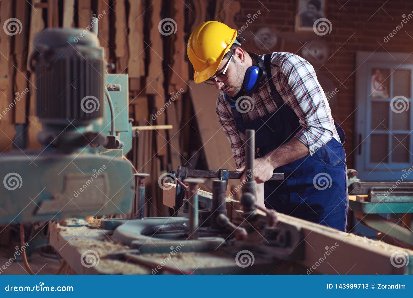 Carpenter Working with Circular Saw at Carpentry Stock Image