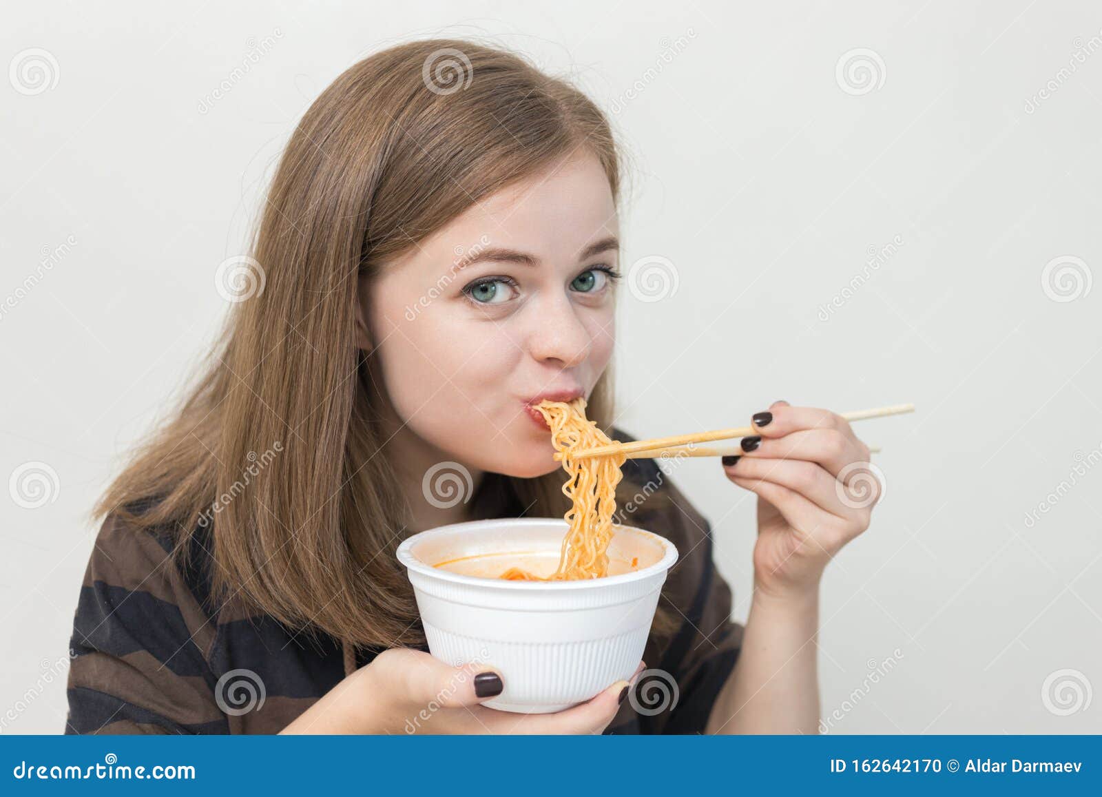 Young Caucasian Girl Woman Eating Instant Noodles Ramen With Chopsticks 