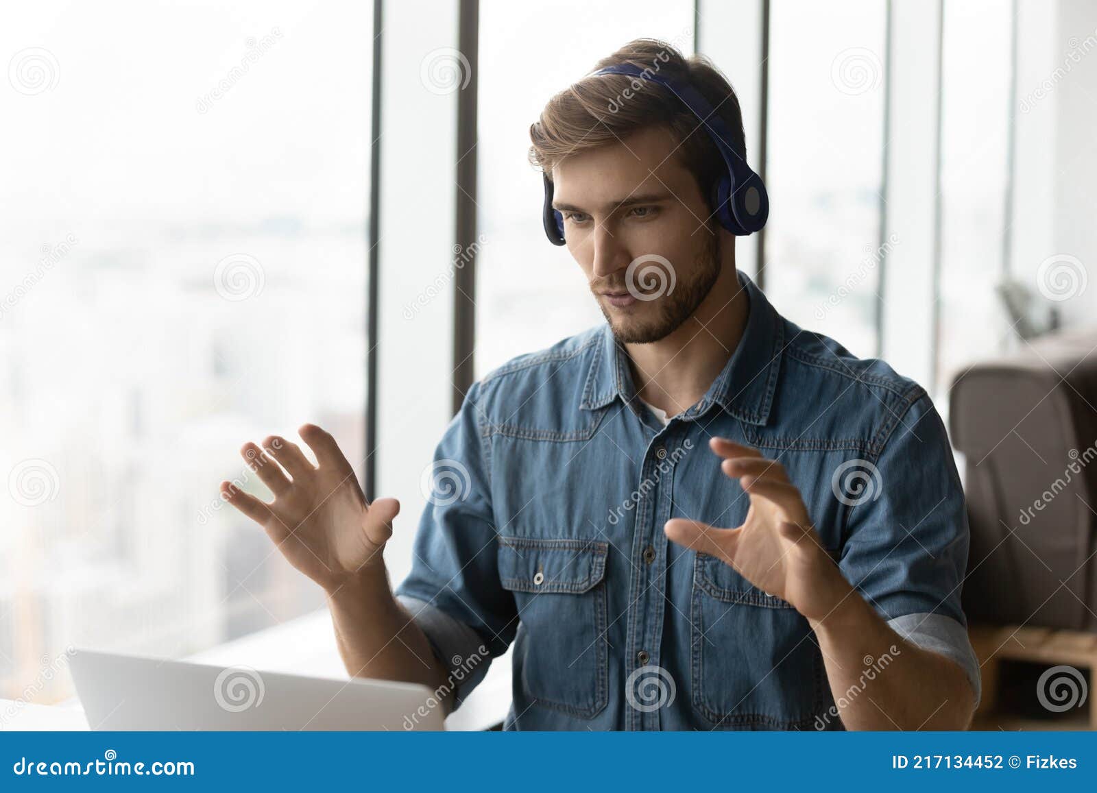 male employee in earphones have webcam zoom call
