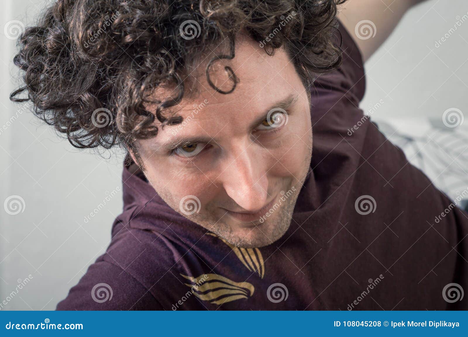 Young Caucasian Man with Curly Hair Looking To the Camera on White ...