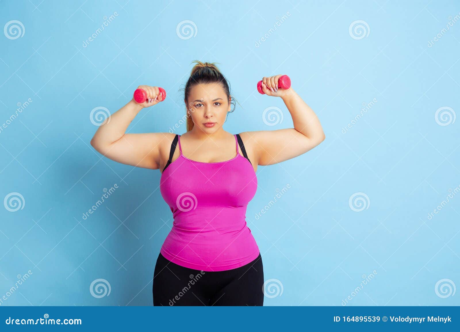 Young Caucasian Plus Size Female Model`s Training on Blue Background ...