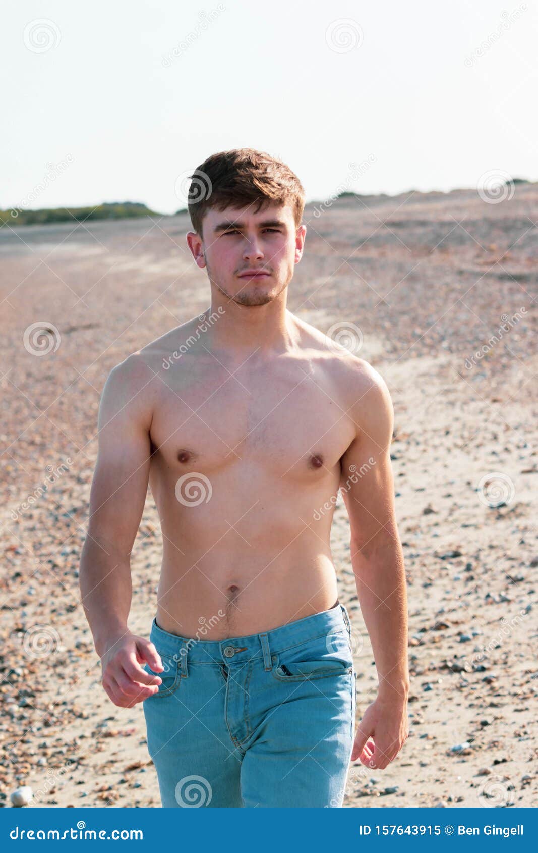 Shirtless on a beach stock image. Image of denim, seashore - 157643915