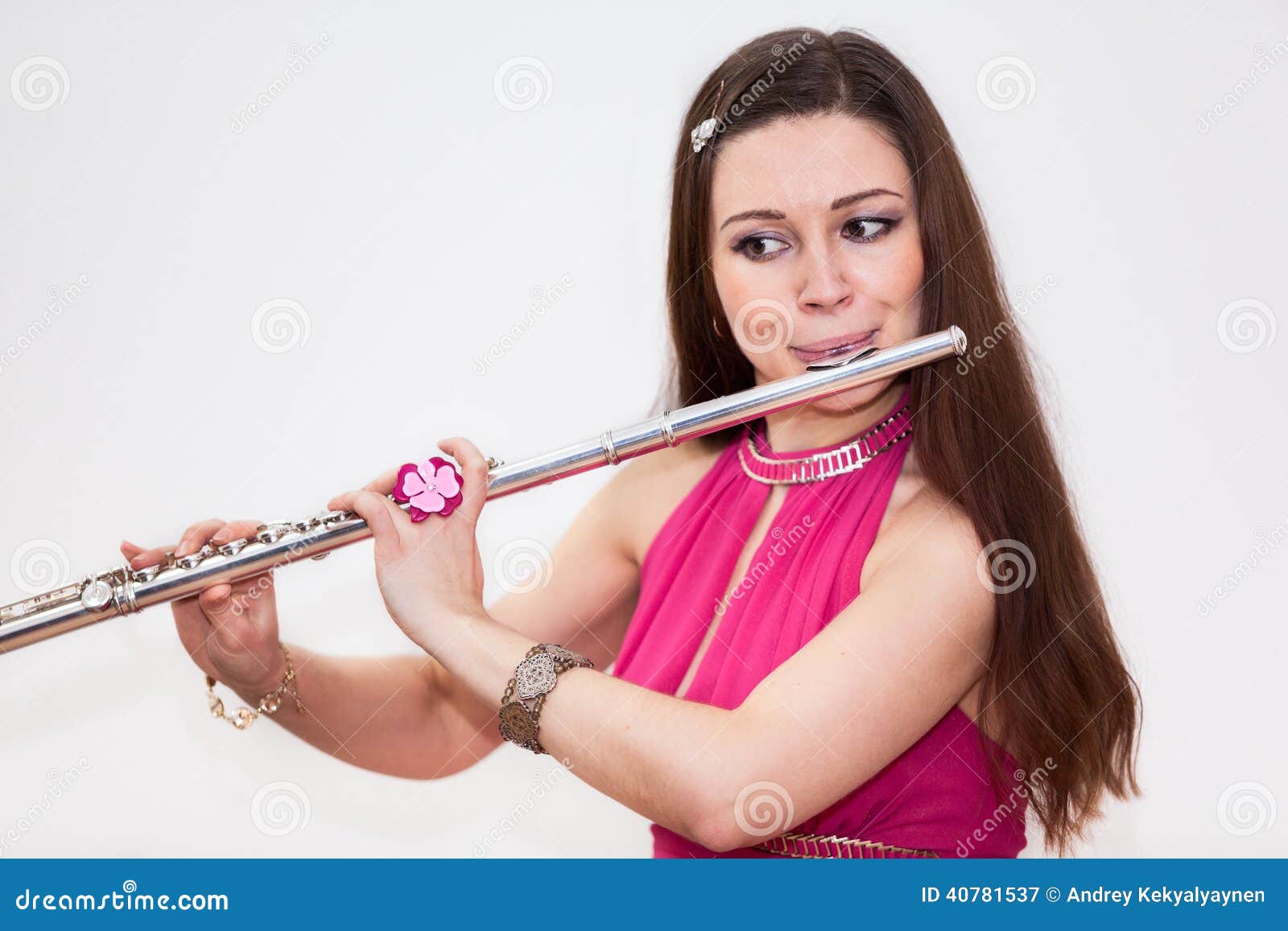 young caucasian woman flutist playing on flute,