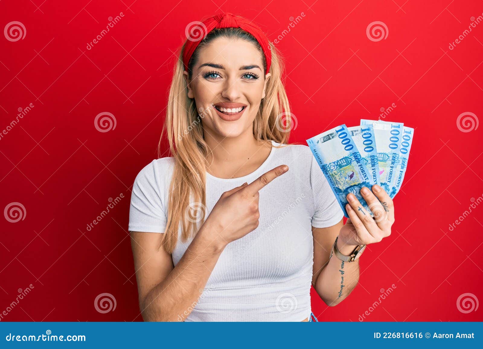 Young Caucasian Woman Holding 1000 Hungarian Forint Banknotes Smiling Happy Pointing With Hand