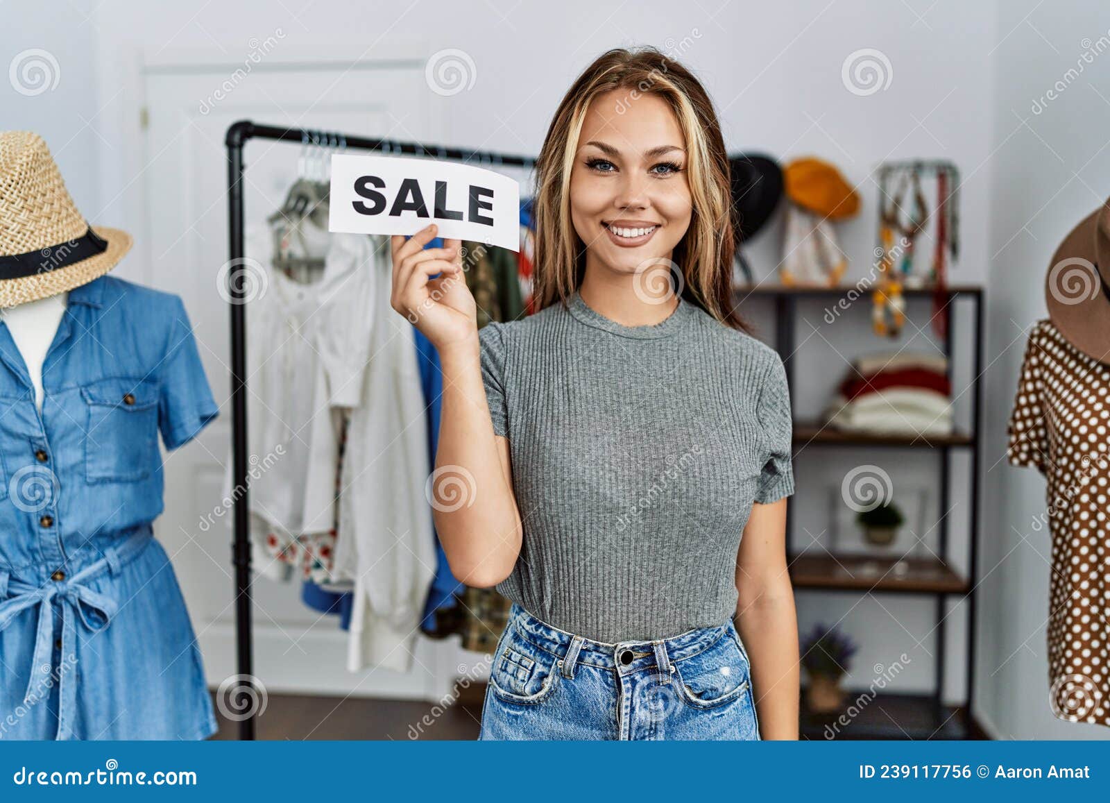 Young Caucasian Woman Holding Sale Poster at Retail Shop Looking ...