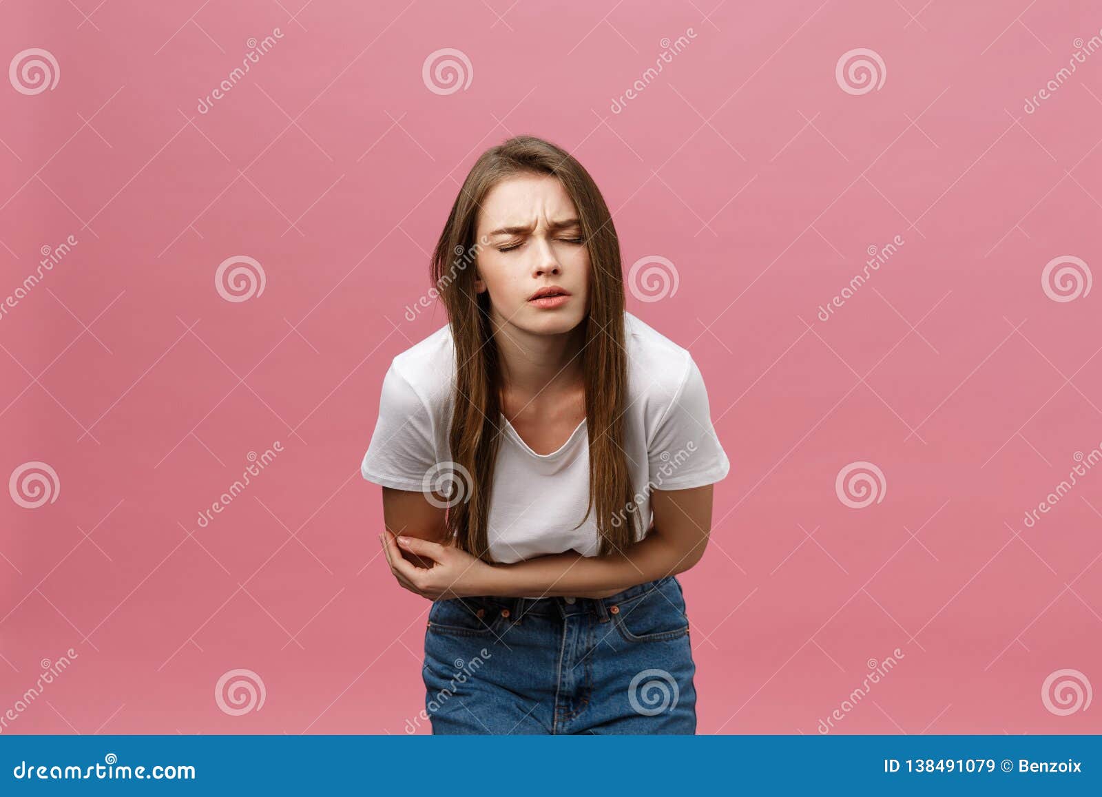 young caucasian woman over  background with hand on stomach because indigestion, painful illness feeling unwell